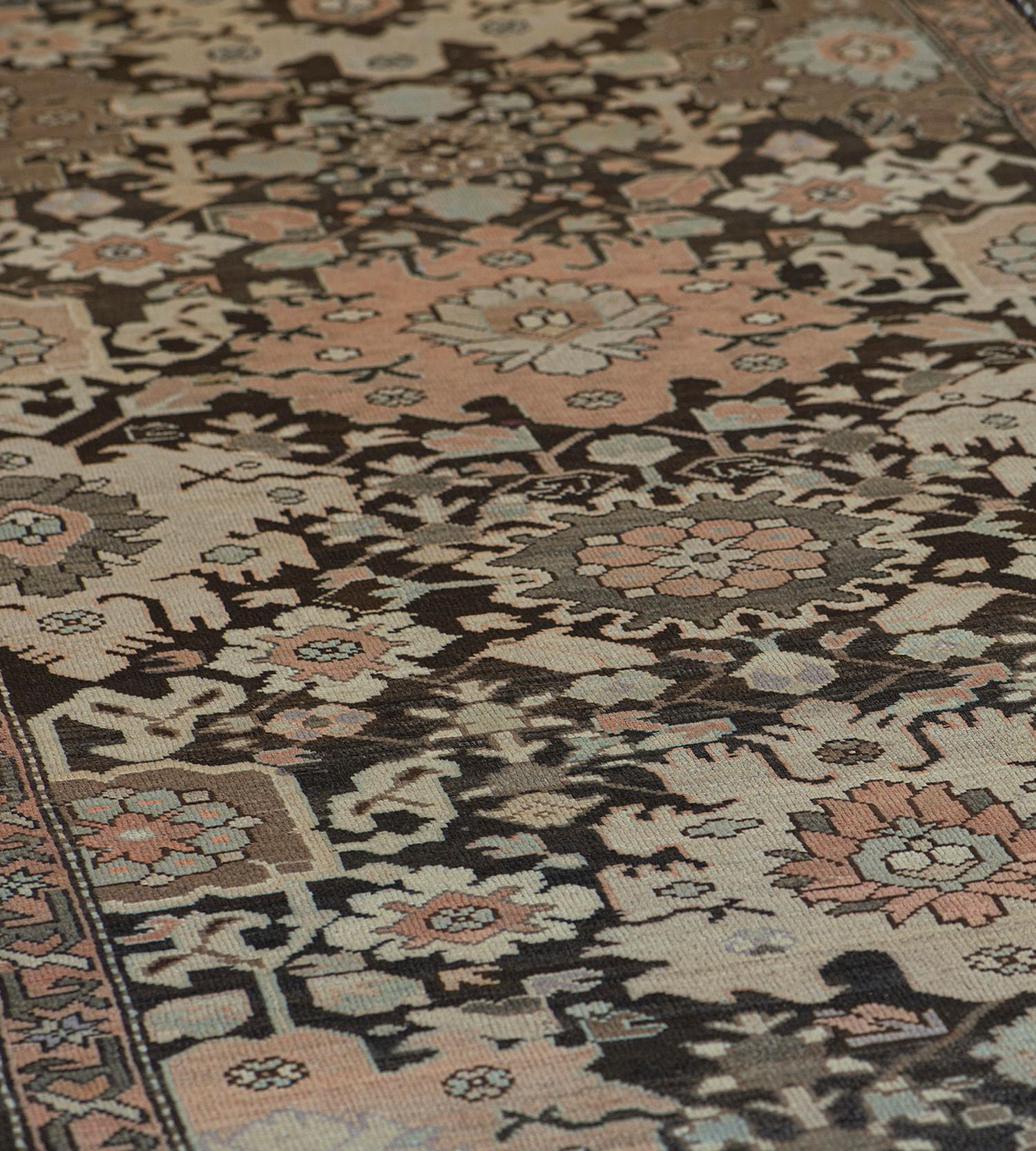 This traditional handwoven Persian Karabagh rug has a deep umber field with broad sweeping palmettes issuing angled floral geometric vine lattice, in a dusty peach angled floral vine border.

This Runner is part of a pair and matches Item Ref: