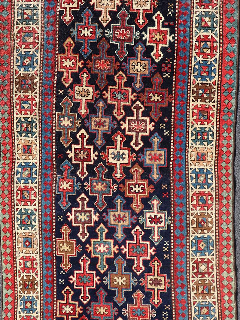 Late 19th Century Kazak Runner with Geometric Design in Tribal Crosses. Country of Origin: Caucasus Type: Kazak Design: All-Over, Sub-Geometric, Medallion Keivan Woven Arts; rug V21-1211 
Measures; 3'3 x 9'1
This piece was hand-knotted in Caucasus