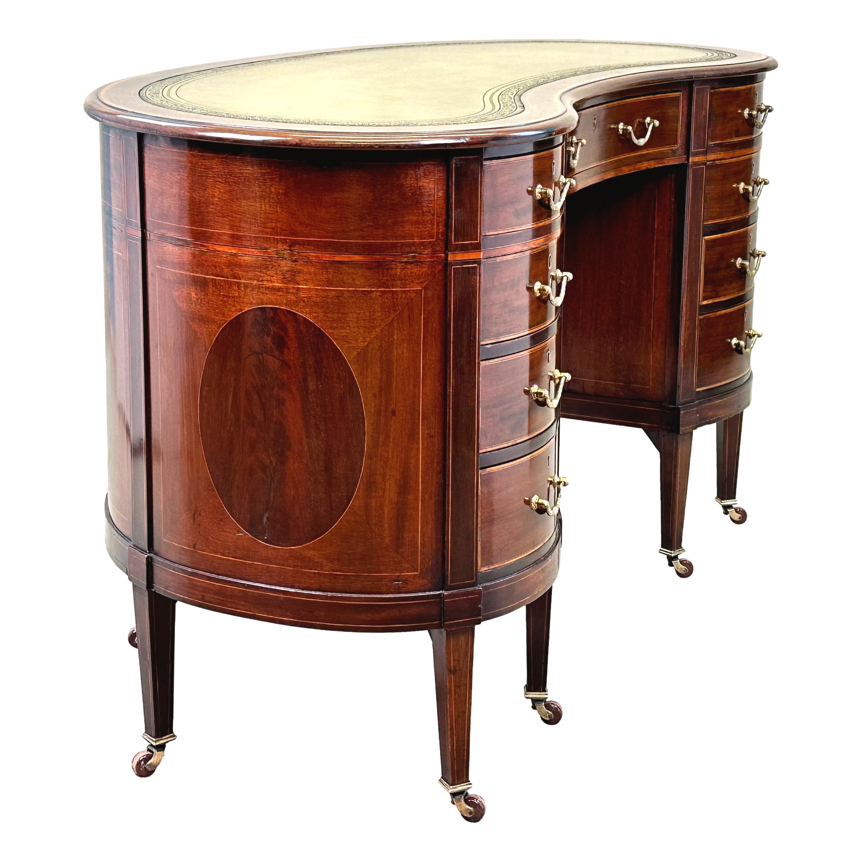 A Fine Quality Late 19th Century Mahogany Kidney Shaped Desk, or Dressing Table, Having Attractive Replacement Tooled Leather Inset Top Over Nine Drawers With Original Brass Handles, Boasting Attractive Inlaid And Banded Decoration Throughout,