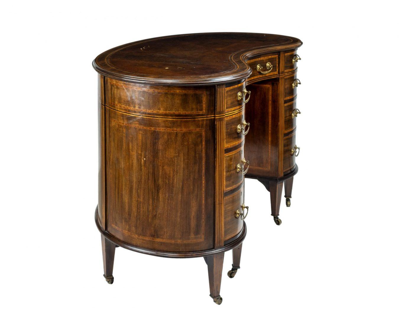 In the manner of Edwards & Roberts, a late 19th century inlaid mahogany kidney shaped nine drawer pedestal desk, on tapering square supports

Edwards and Roberts were one of the best English antique furniture cabinet makers of the second half of