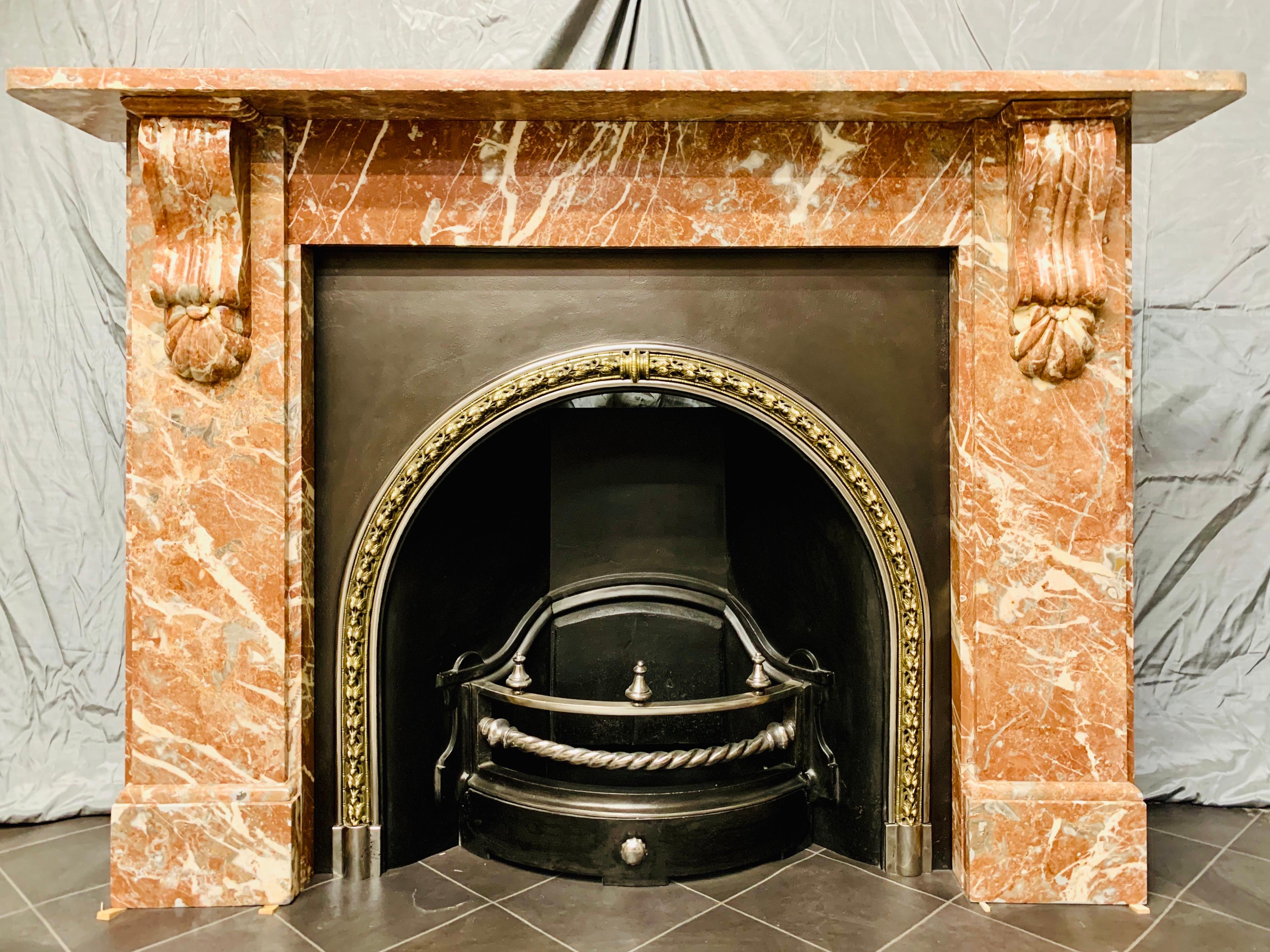 A large late 19th century variegated Languedoc Marble fireplace surround exhibiting excellent tones of elongate dove grey and white calcite crystals. A generous square shelf sits above a plain frieze flanked by large well carved corbels and under