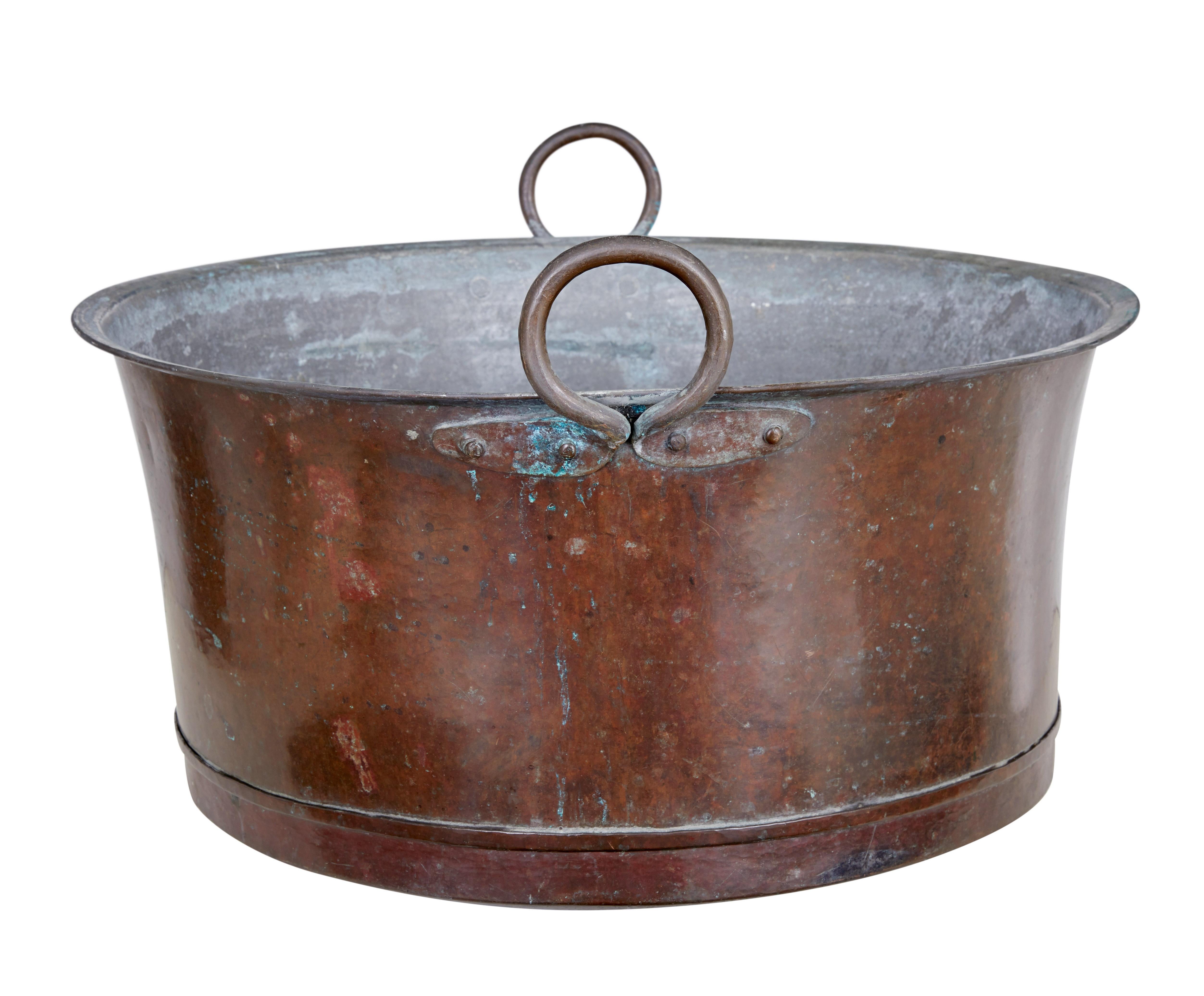 Late 19th century large copper cooking vessel, circa 1890.

Large arts and crafts cooking pot, ideal for use today as a log bin or paper bin.

Fold over rim with applied ring handles.

Expected surface fading, surface marks and minor dings.