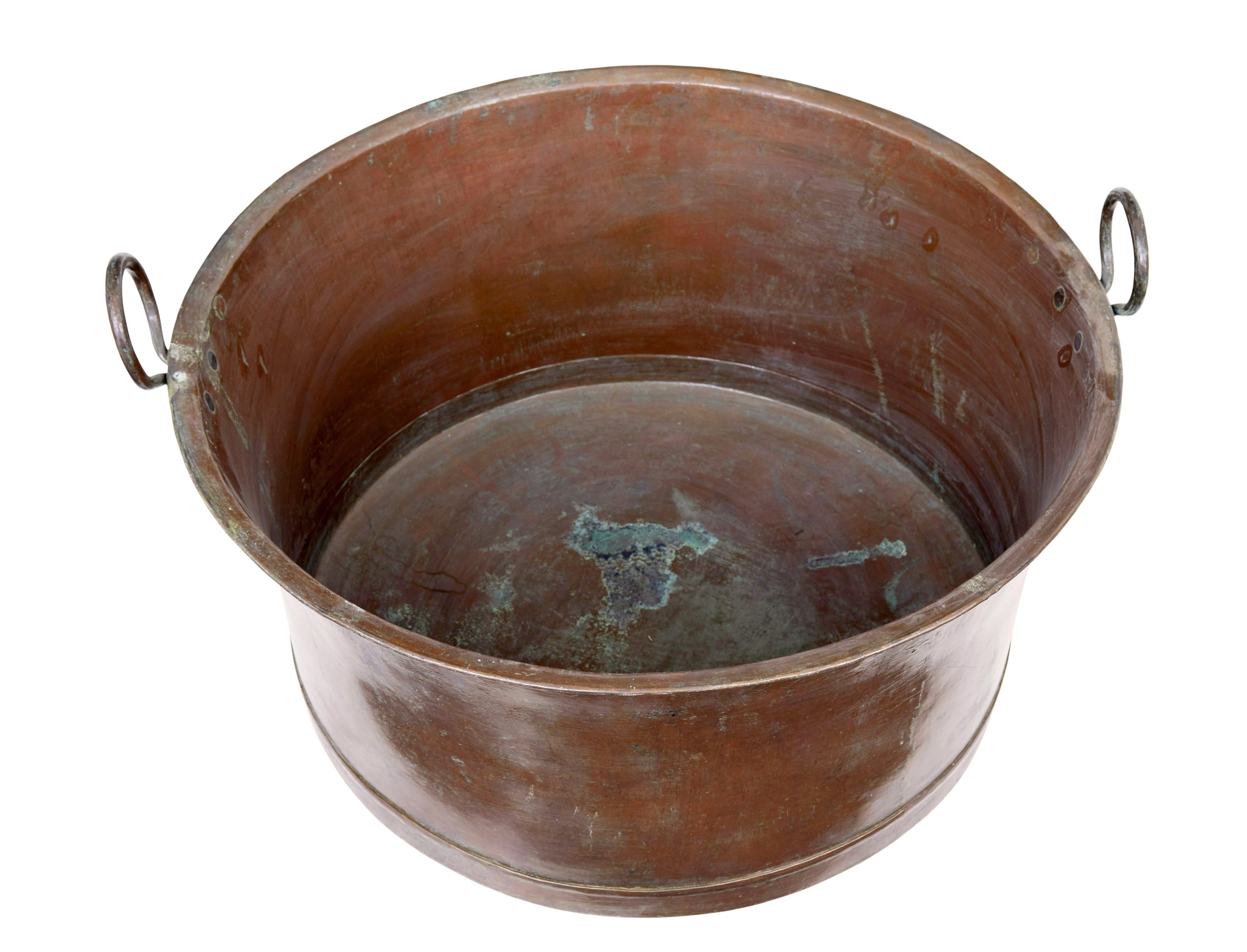 Late 19th century large copper cooking vessel circa 1890.

Large copper cooking pot with rounded bottom and looped handles.  Ideal for today as use as a log bin or a cloakroom shoe tidy.

Expected surface marks, presented with it's original patina.