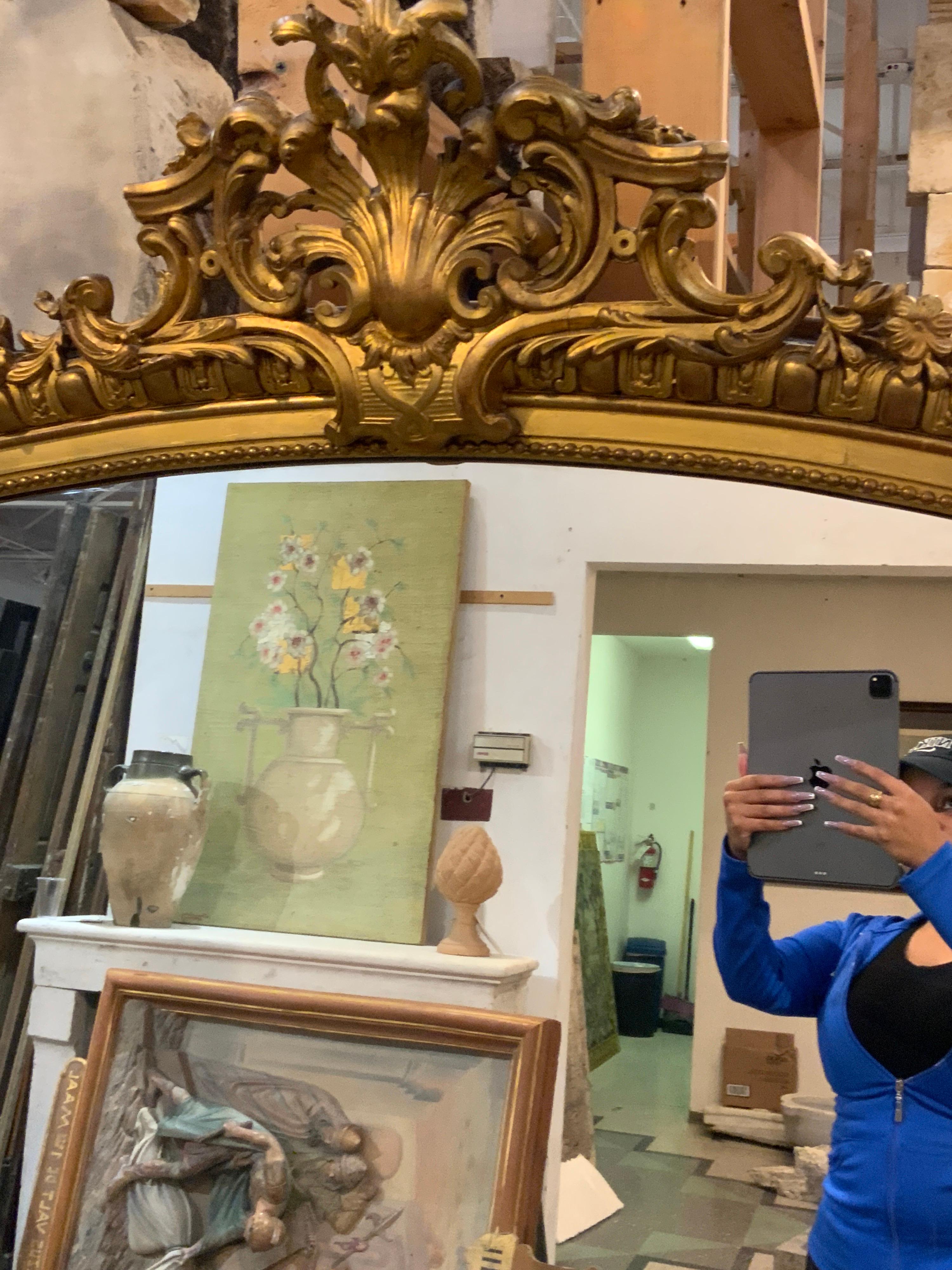 This eye-catching mirror is almost 6 ft in height. Item features intricate details along the top. Origin; France.