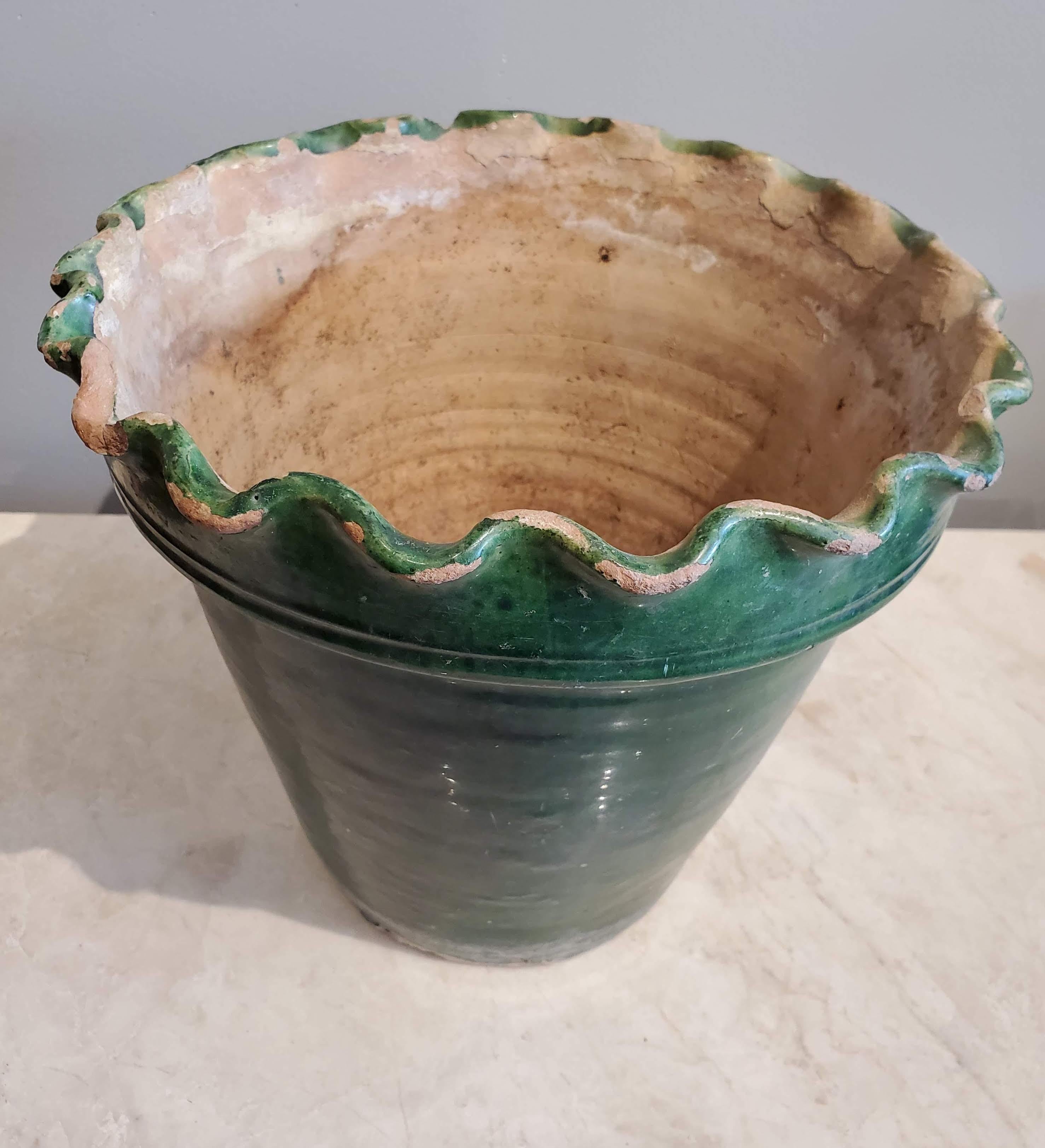 This late 19th century green glazed terracotta flower pot is a beautiful example of French provincial design. Lovely green color still maintained with only slight chips to original paint.
Provence, circa 1880.
Measures: 9