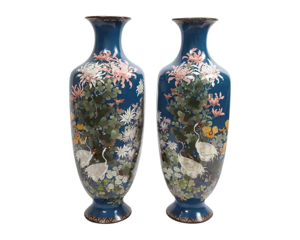 A large pair of Japanese Meiji Period Blue-Ground Cloisonne enamel vases, 19th century. Very nice quality, with cloisonne enamel throughout, depicting cranes, flowers and blossoms with a nice blue background. Measures: 38″ high x 20″ wide x 16″ deep