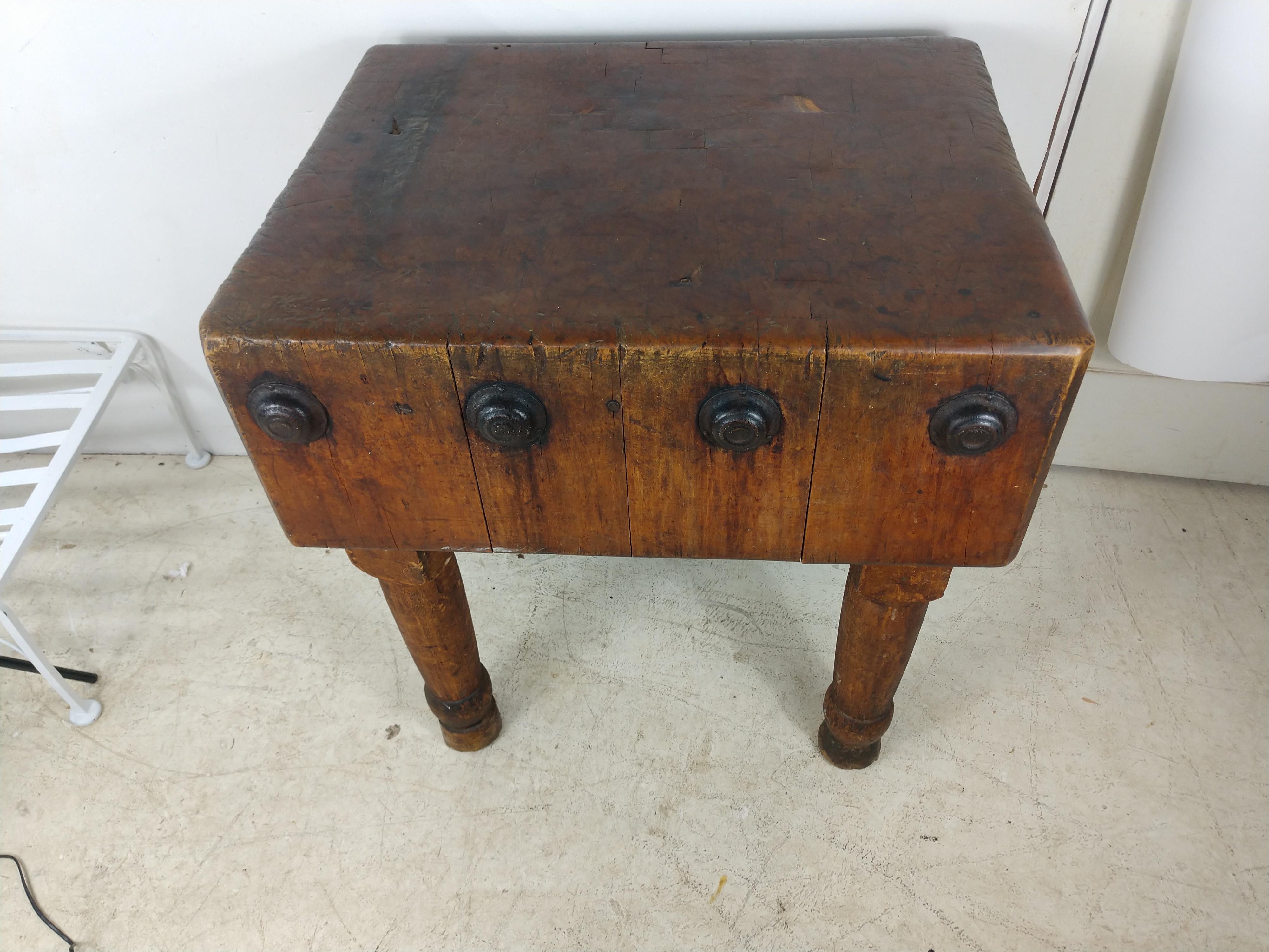 Fabulous and large, 29.25 x 25.25 x 31.25 H in size maple butchers block table. From a Kingston NY butcher that closed in the sixties. Great patina Very sturdy. Beautiful turned legs with plenty of patina and some wear to the feet. Iron caps which