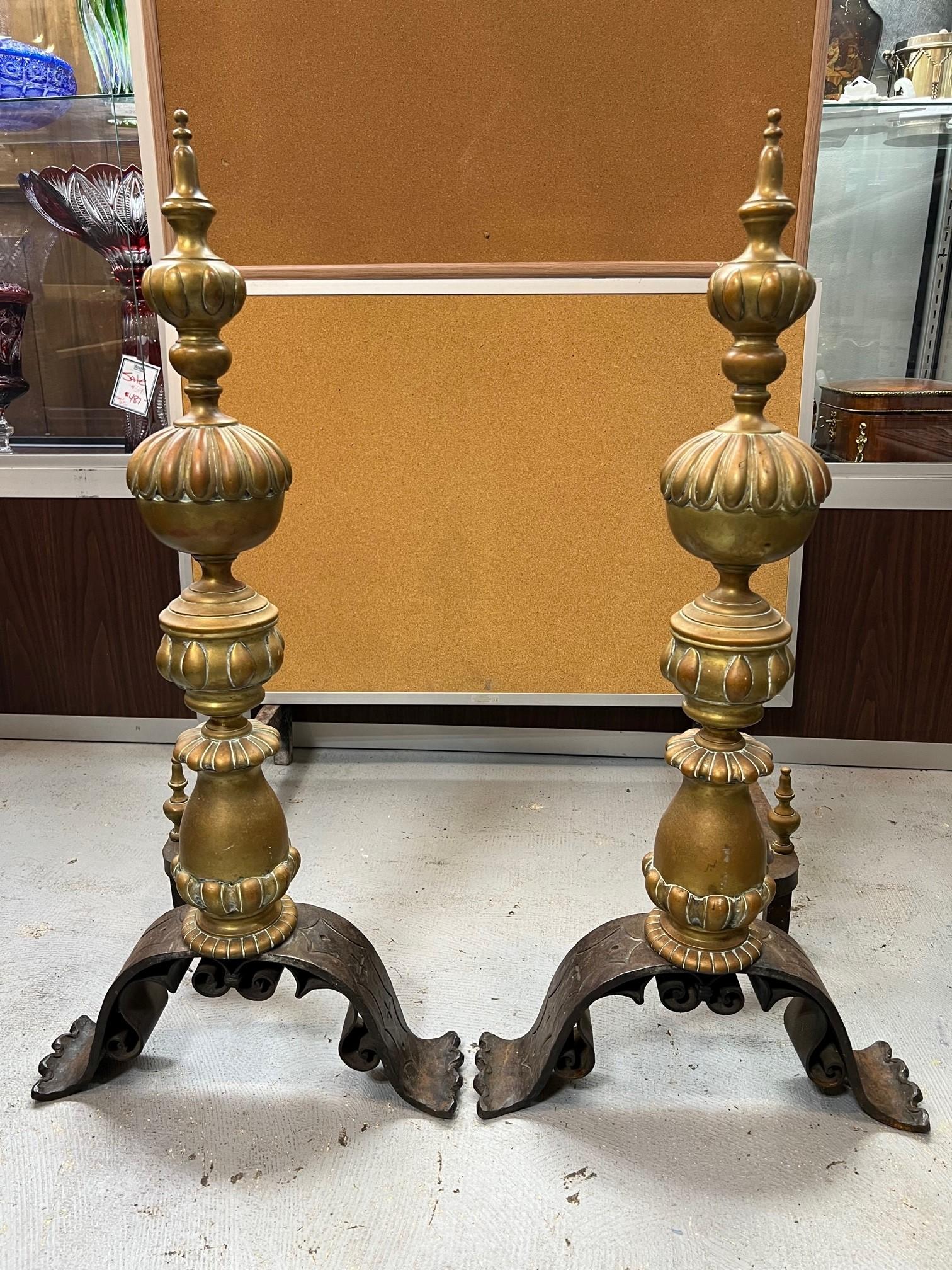 A great pair of Baroque style andirons with a great combination of bronze and iron that gives this pair of andirons a good look. They have a nice patina and are a good size with a long pair of iron dogs or billety bars. 