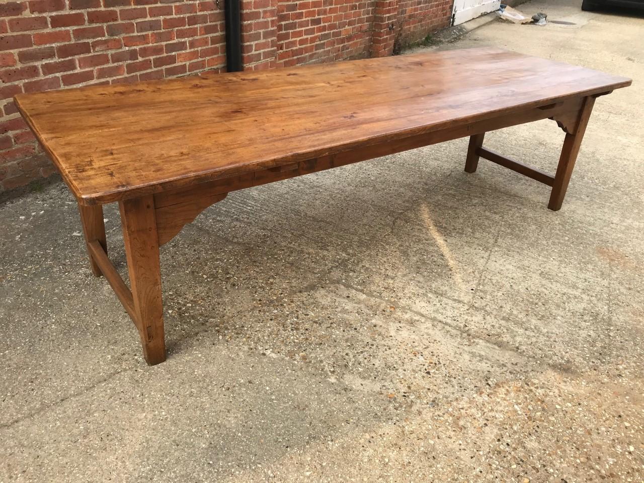 Late 19th century large pale elm farmhouse table. Table has a four plank beautifully figured top that stands on a pretty apron with end stretcher. Gorgeous table with alot of character. A exciting rare find.
