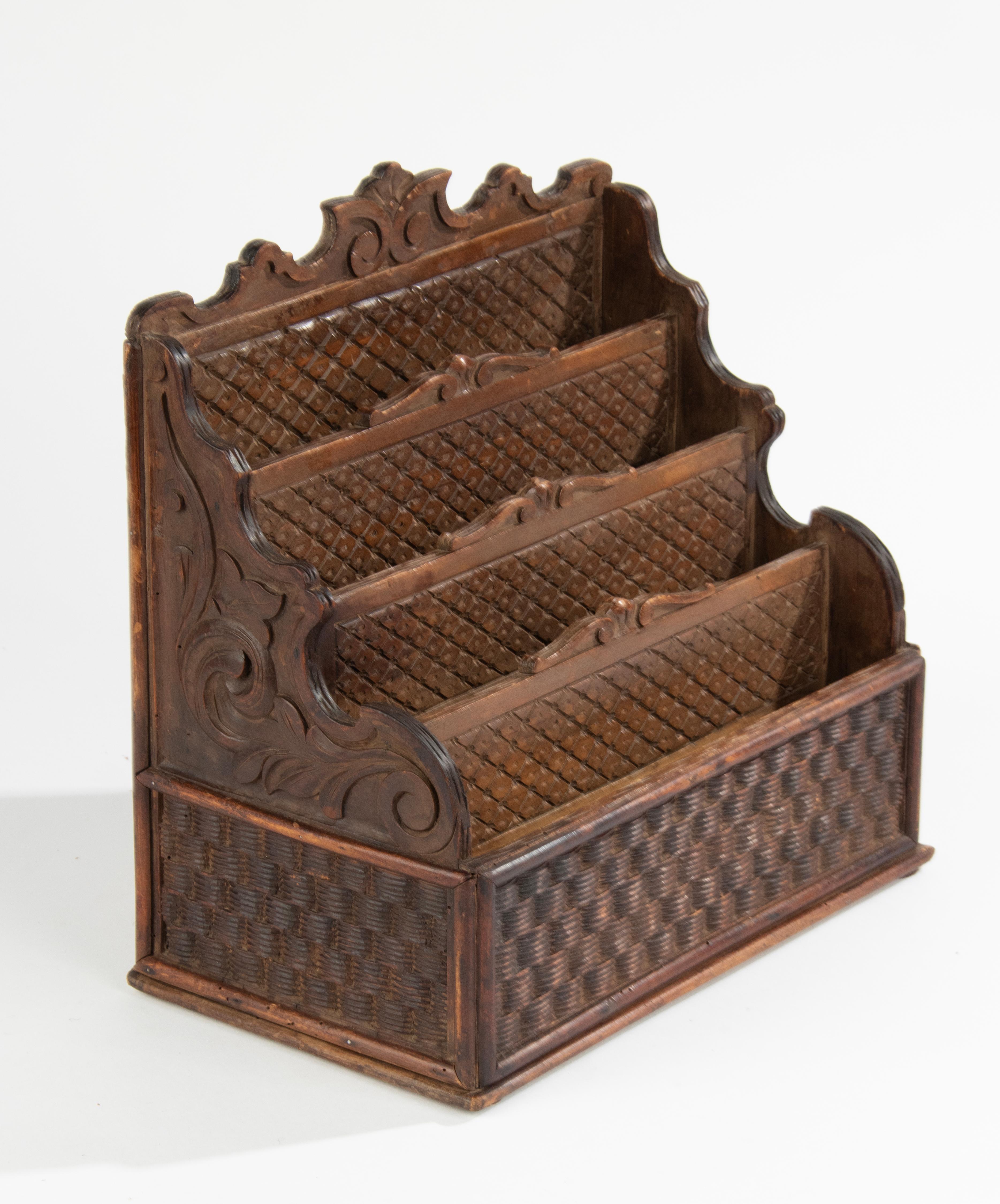 A large antique letter rack, made of carved wood. The wickerwork is also made of carved wood. With three compartments. Made in France around 1890-1900.
Dimensions: 35 (h) x 36 (w) x 21 (d) cm.