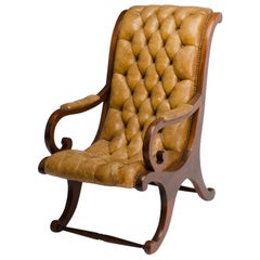 A late nineteenth century, campaign style leather armchair. 