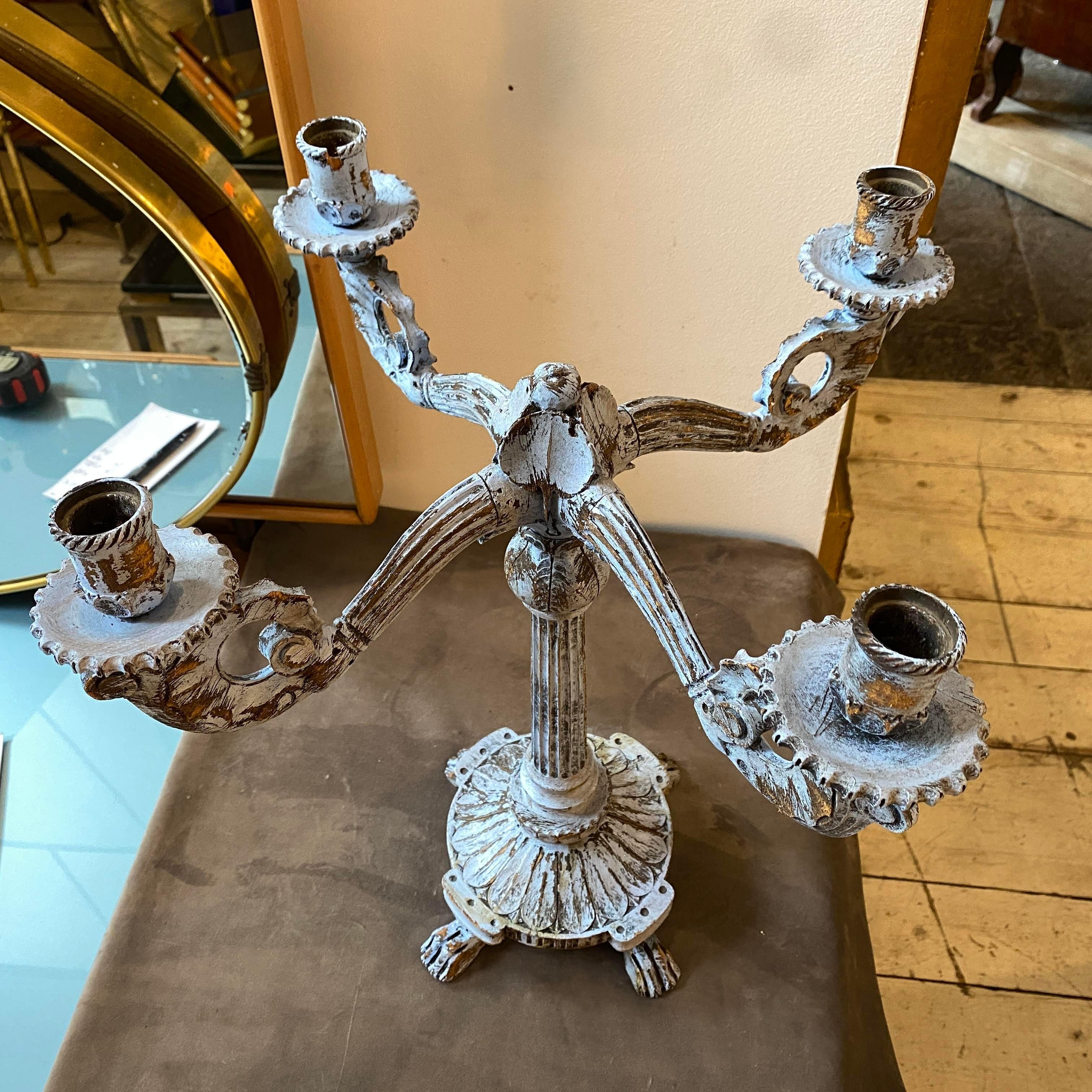 An antique hand-carved wood candelabra, blue painted wood as normal signs of use and age. It has been made in Sicily in the second part of 19th Century