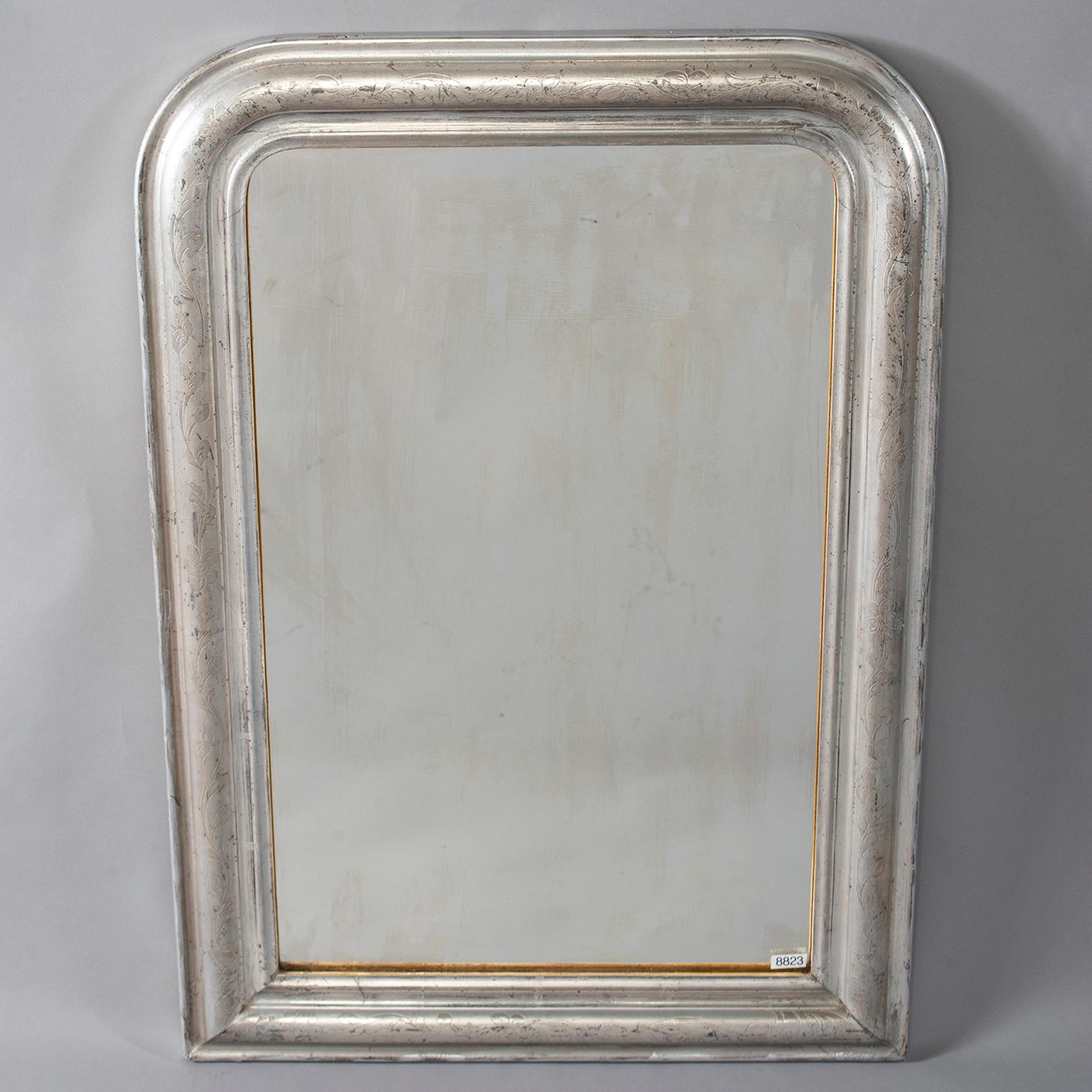Louis Philippe mirror with silver gilt frame that has subtle, etched design of leaves and vines. Other similar silver gilt mirrors in various sizes available at the time of this posting, circa 1880s.