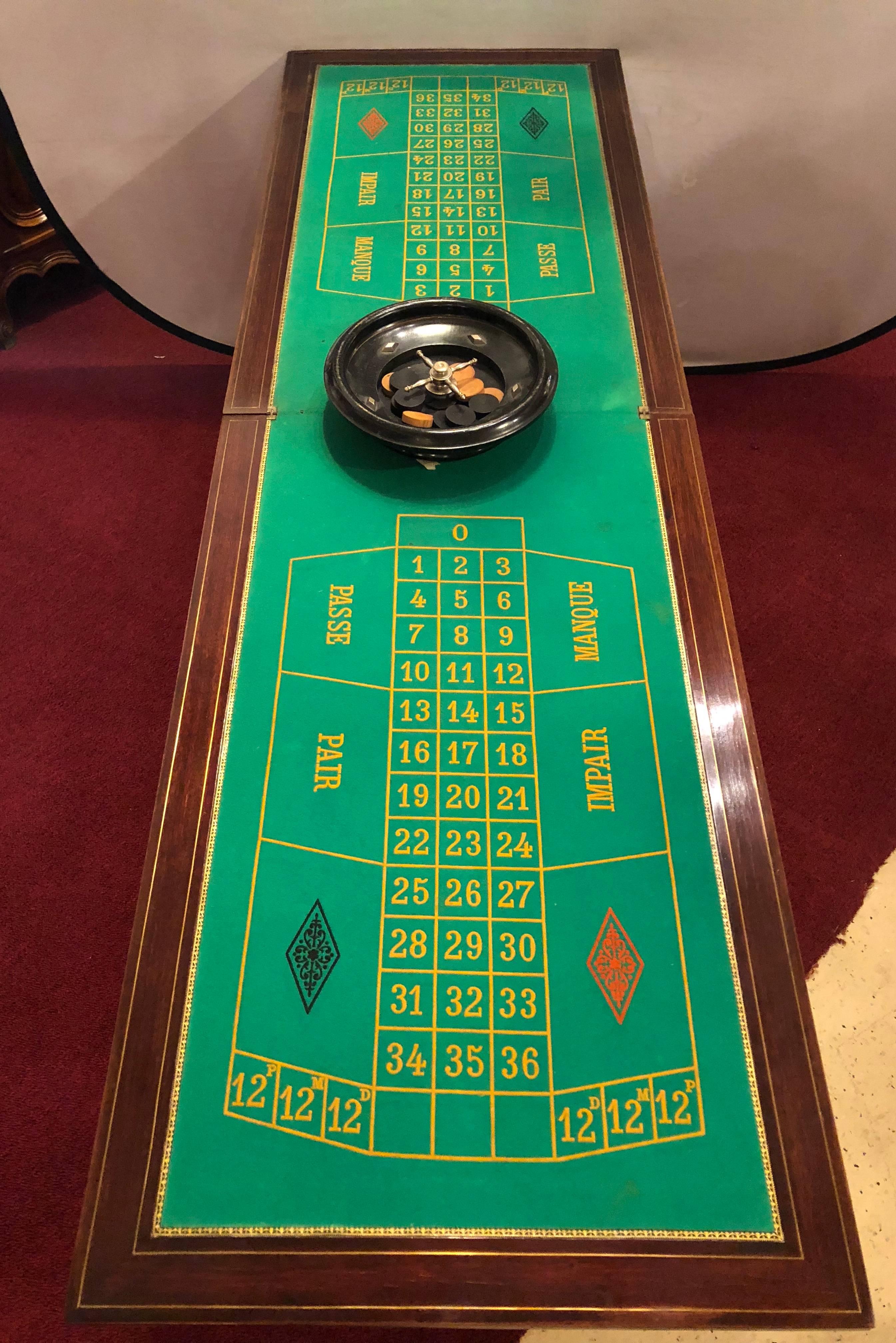 A 19th century Louis XVI Roulette Games / flip-top card or gaming table. This fully extended, 79.5 inch, roulette table can entertain many as it sits on sleek tapering reeded legs with bronze sabots that support a boule inlaid apron with ebonized