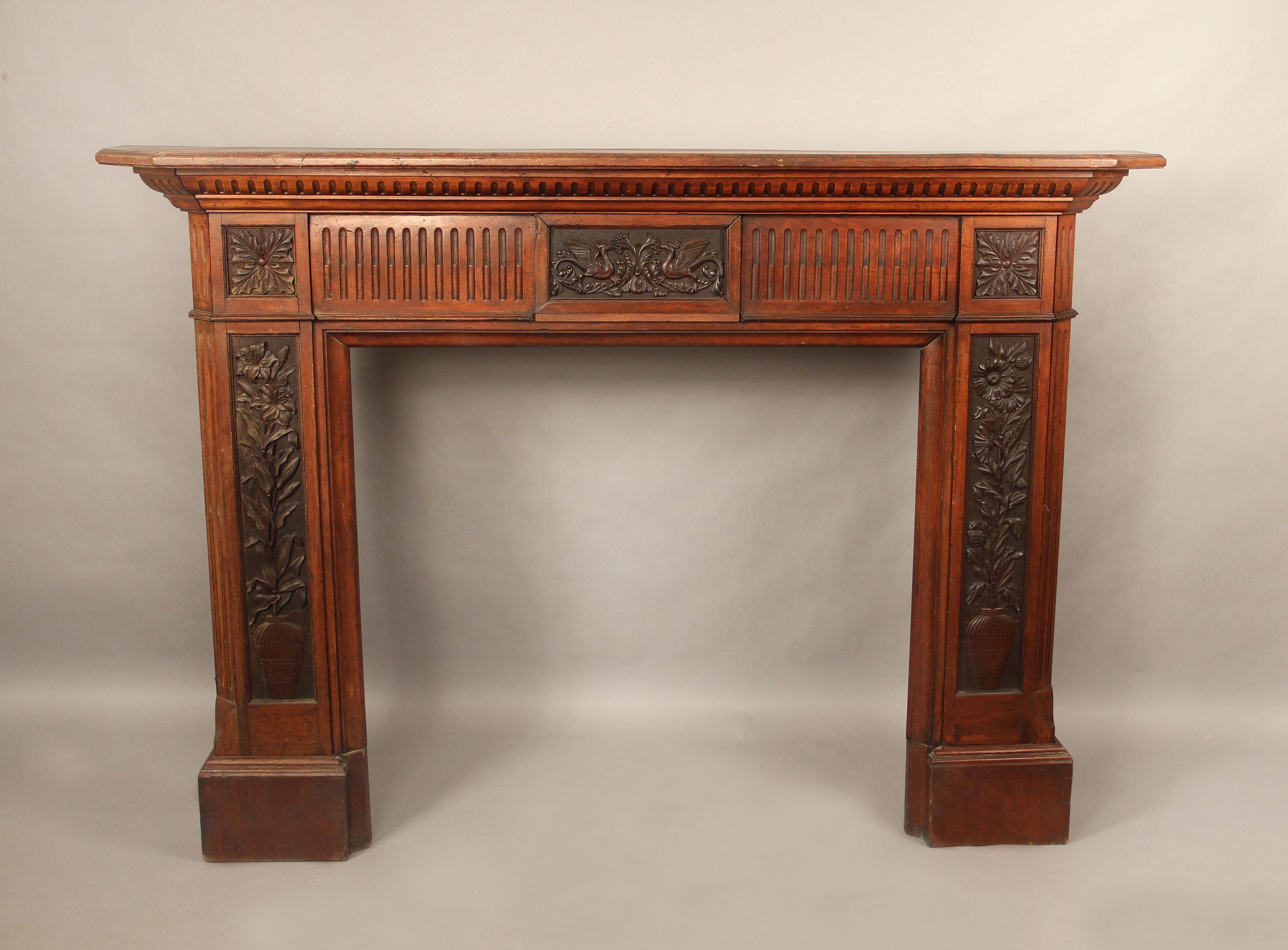 Late 19th century Louis XVI style carved wood fireplace surround

The large and hand-carved frieze centered with a plaque depicting the mythological bird Phoenix, each leg with a carved plaque of potted flowers with leaves.

Outside