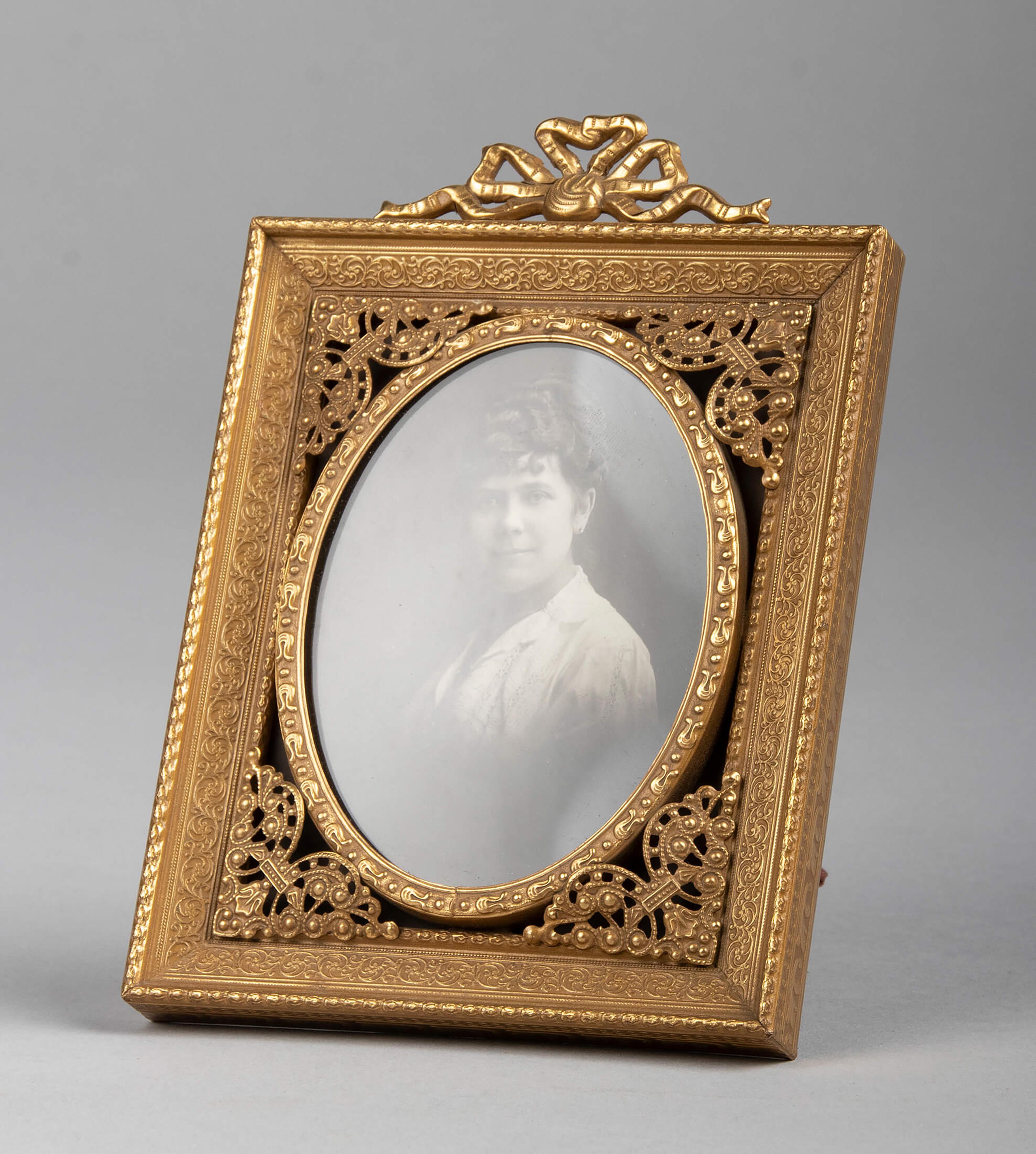 Small antique copper/brass photo frame. The frame has refined edits, made with great attention to detail. The back is covered with burgundy red fabric, the whole is in good, original condition.