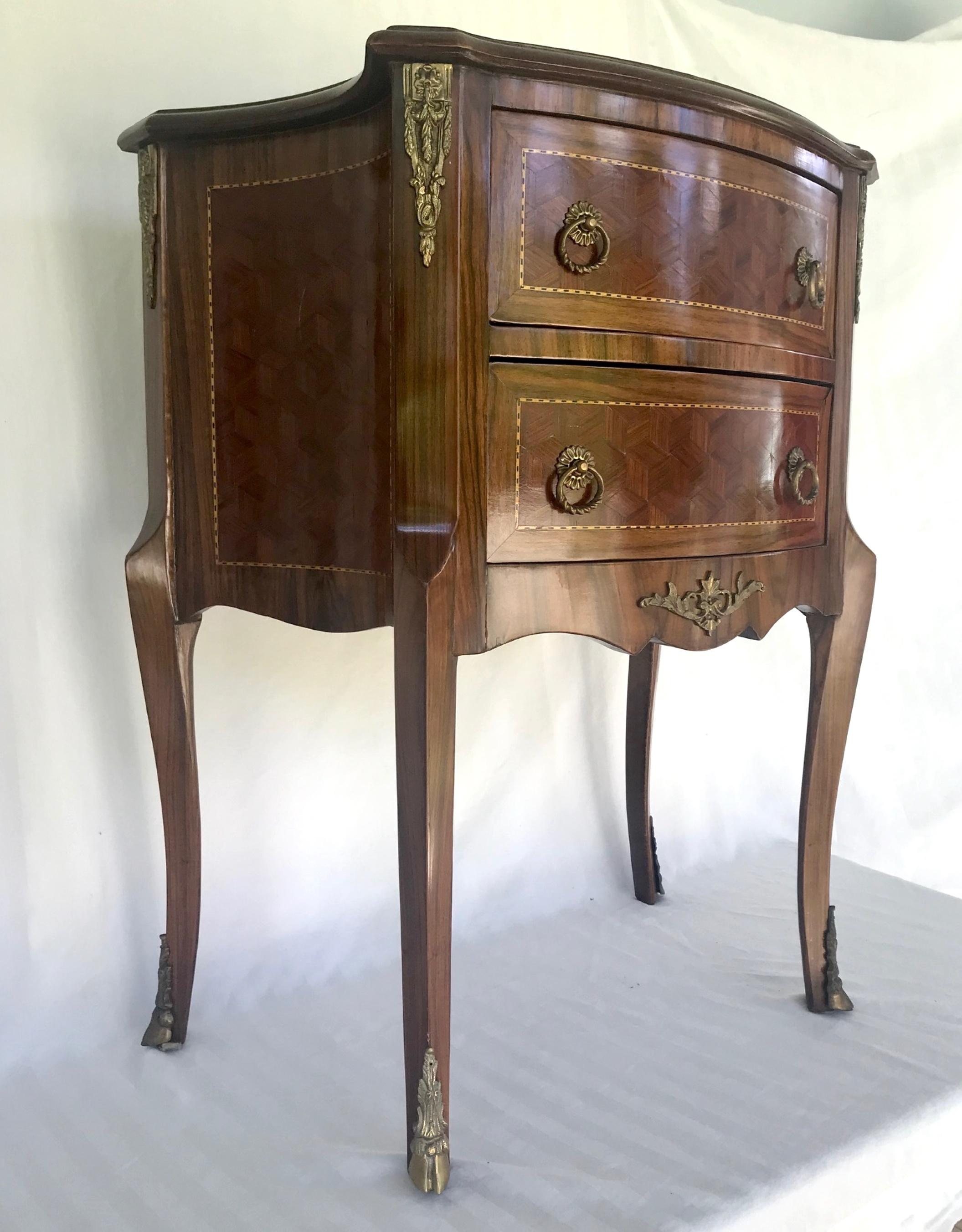 Late 19th century Louis XVI style kingwood Marquetry 2-drawer commode

This glowing tulip and kingwood Marquetry commode in the Louis XVI style is richly adorned with gilded bronze ornaments. The Fine veneer and marquetry work of the Louis cube