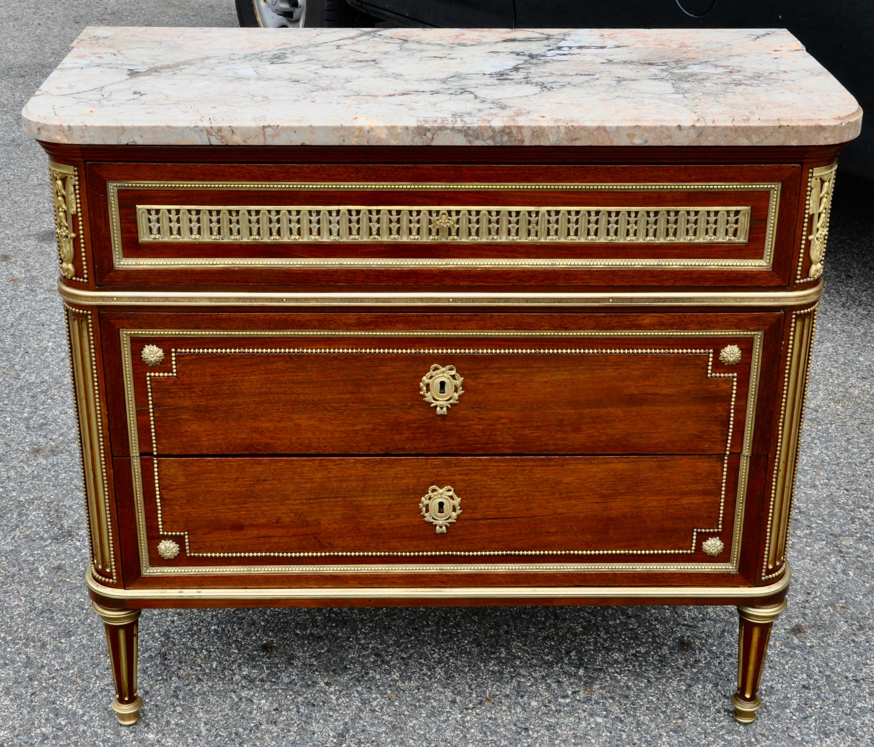 A very fine 19th Century Louis XVI style marble-top commode in the style of Paul Sormani. Original marble and mounts. Mahogany throughout with oak secondary wood. 
