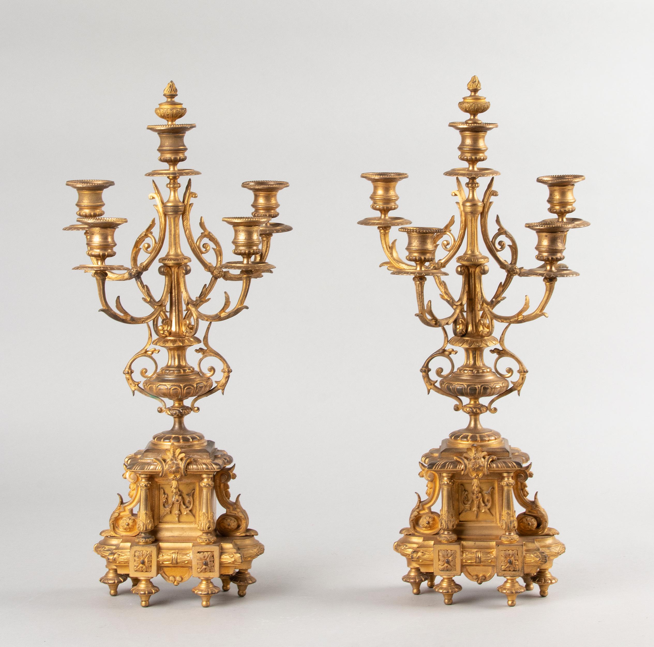 A fine pair of French candelabras, made of fire-gilt bronze, in Louis XVI style. Each candlestick have five candleholders. The center candle have a cap at the top, it can take of and should be used for quenching the candles. This pair of