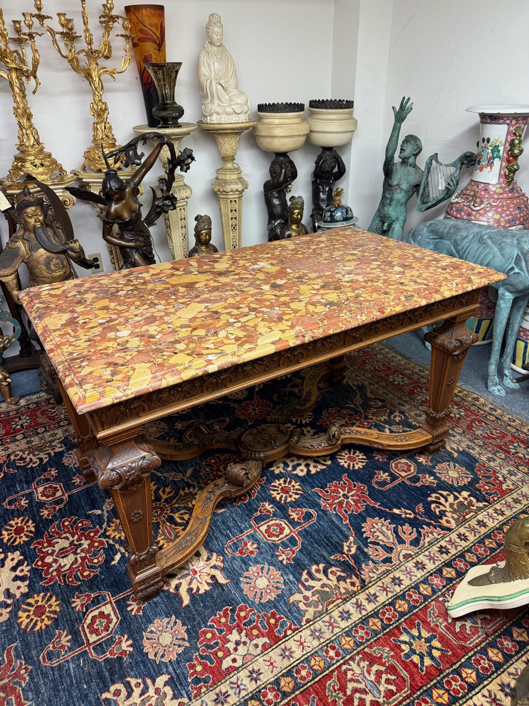 Beautiful Late 19th century Louis XVI style Rouge marble top center table with a spectacular undercarriage with an impressive center supporting the four finely carved legs. The center table is in good condition but the marble needs to be polished