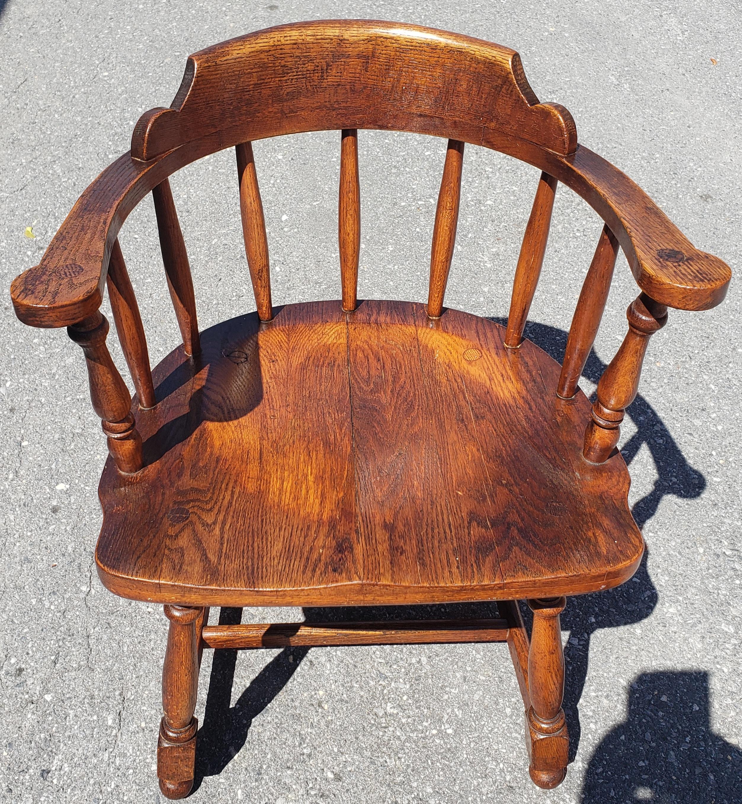 Low-back, bow-back Windsor chairs with armrest. Rock solid oak construction with metal
Chair measures 24