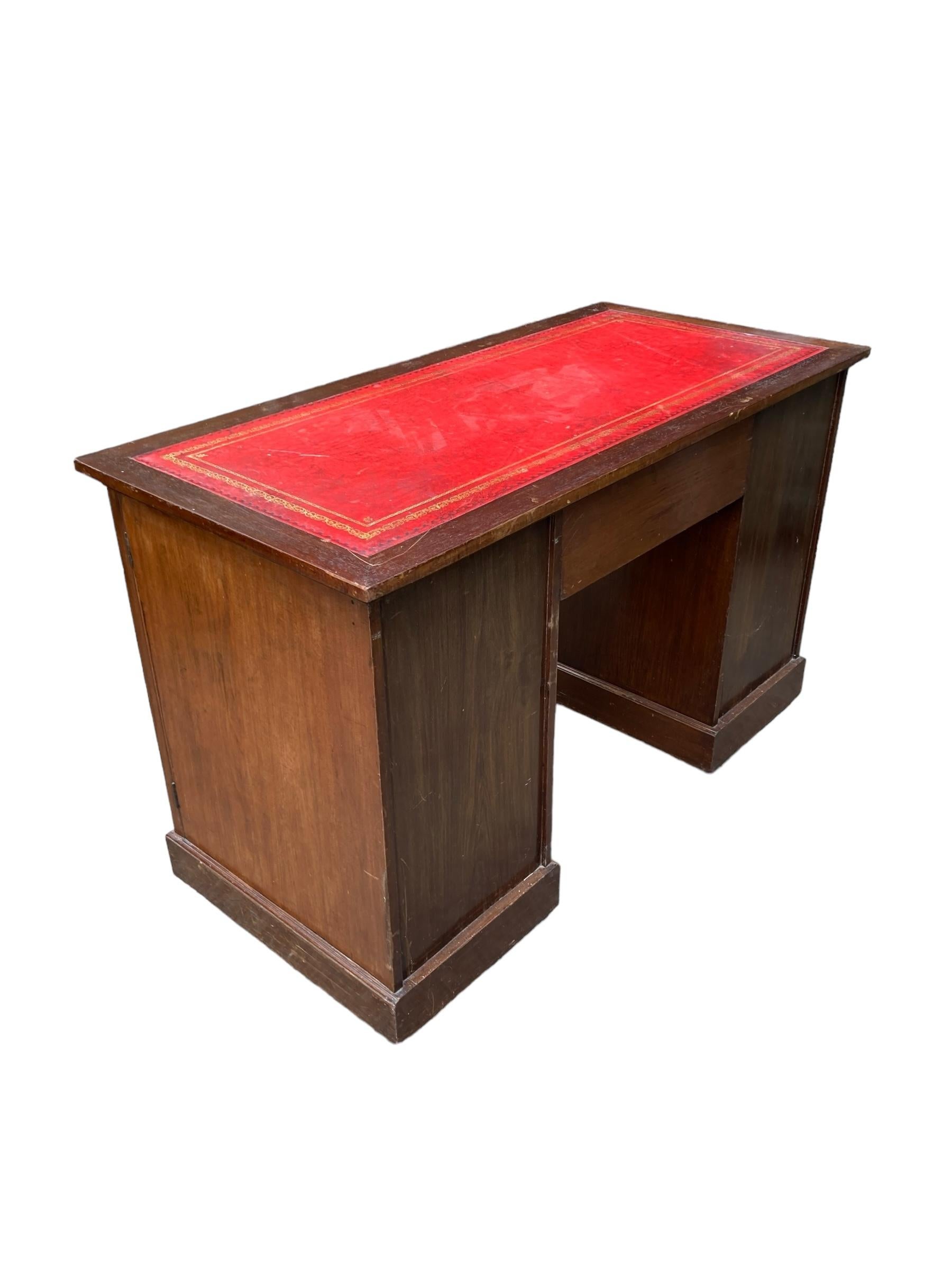 Late 19th Century Mahogany and Burr Walnut all in one Captains Desk on casters. Original red leather top. Single drawer in centre with brass swan neck handles. Two panel doors either side with single shelf. 

H: 77cm

W: 123cm

D: 59cm

Knee hole