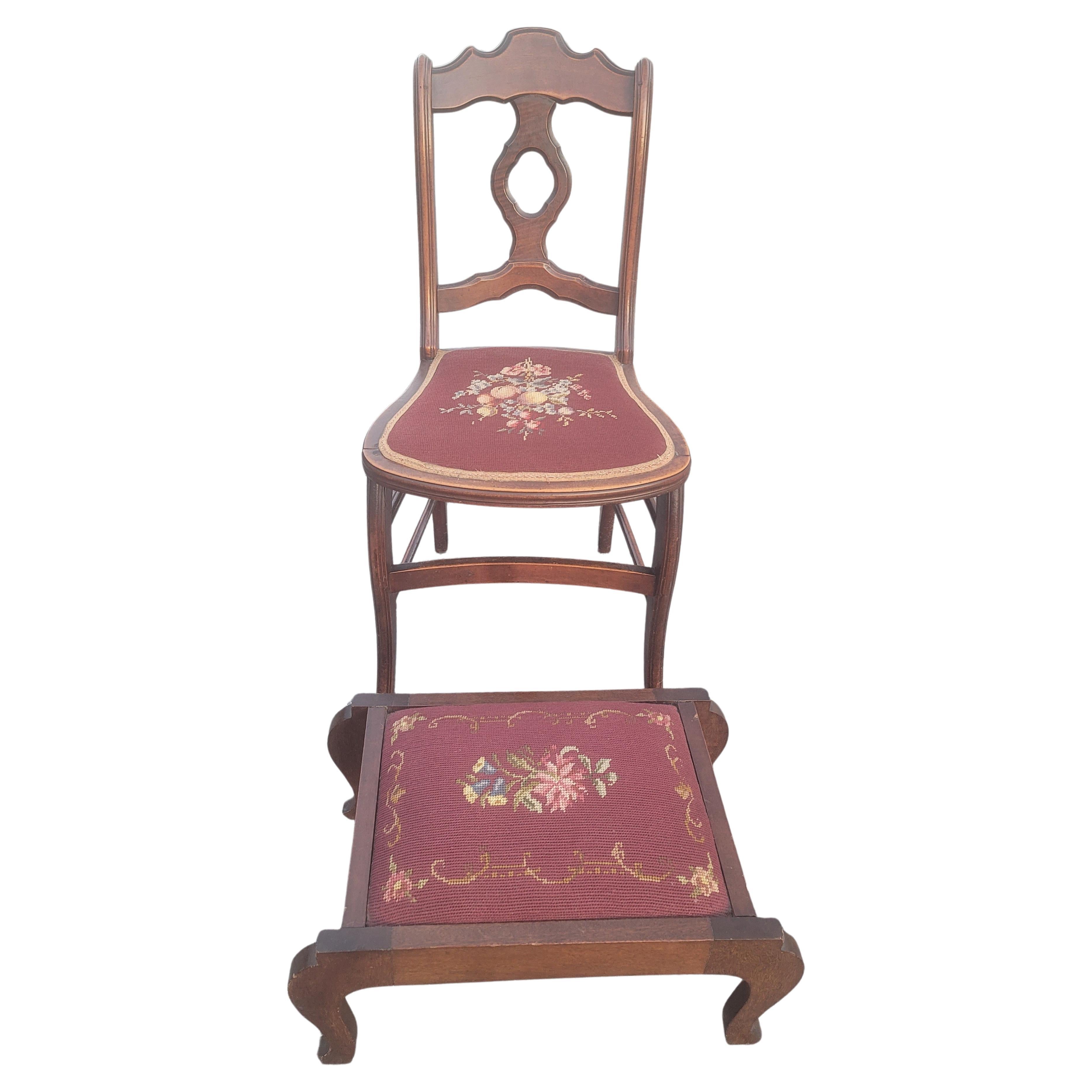 Late 19th century victorian mahogany and needlepoint upholstered chair with matching footstool. 
Chair measures 17