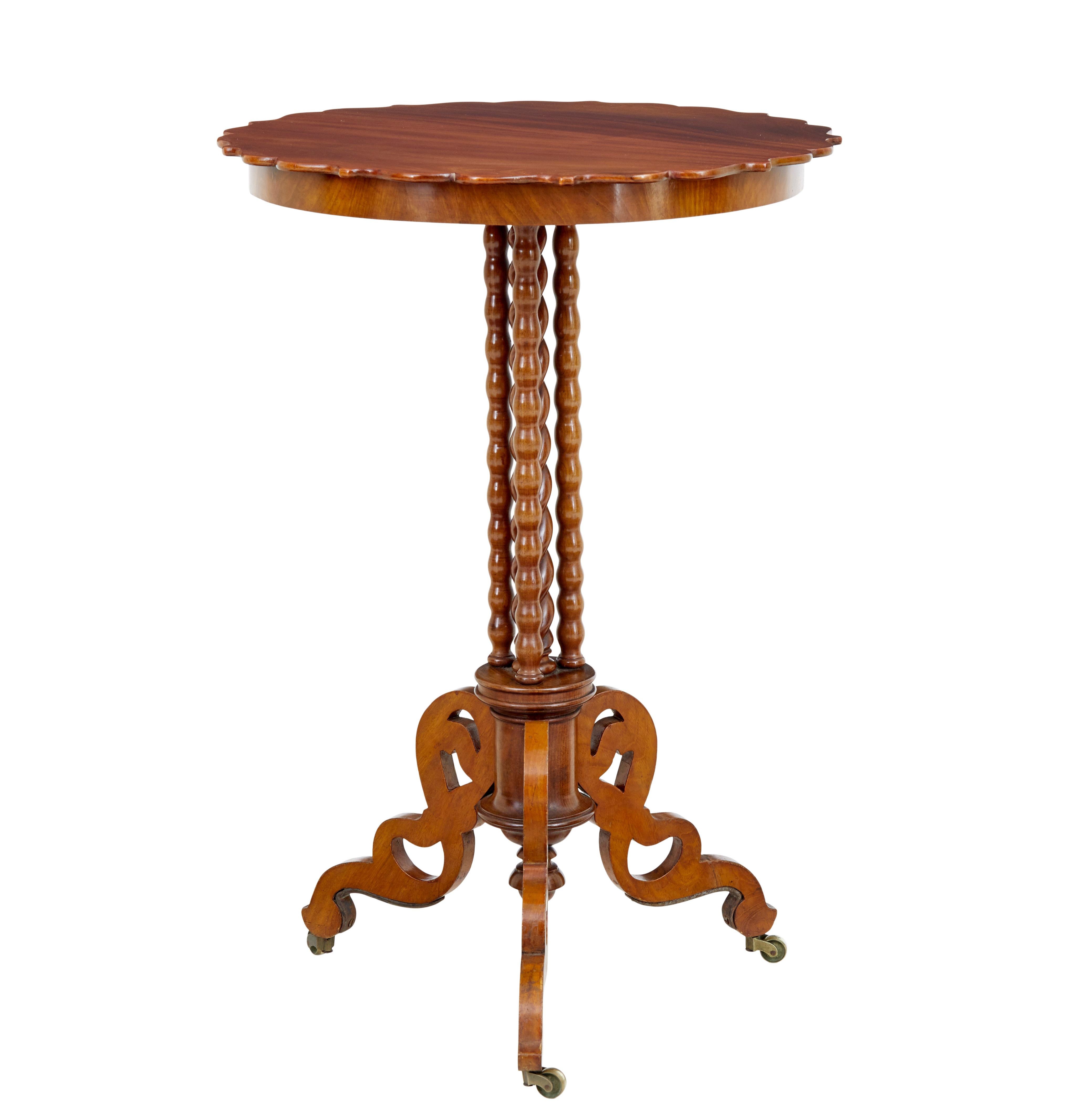 Late 19th century mahogany bobbin turned occasional table, circa 1890.

Scalloped shaped circular top, which sits on a stem of 1 barley twist stem surrounded by a further 3 barley twist supports, all supported on 3 fret cut scrolling legs and