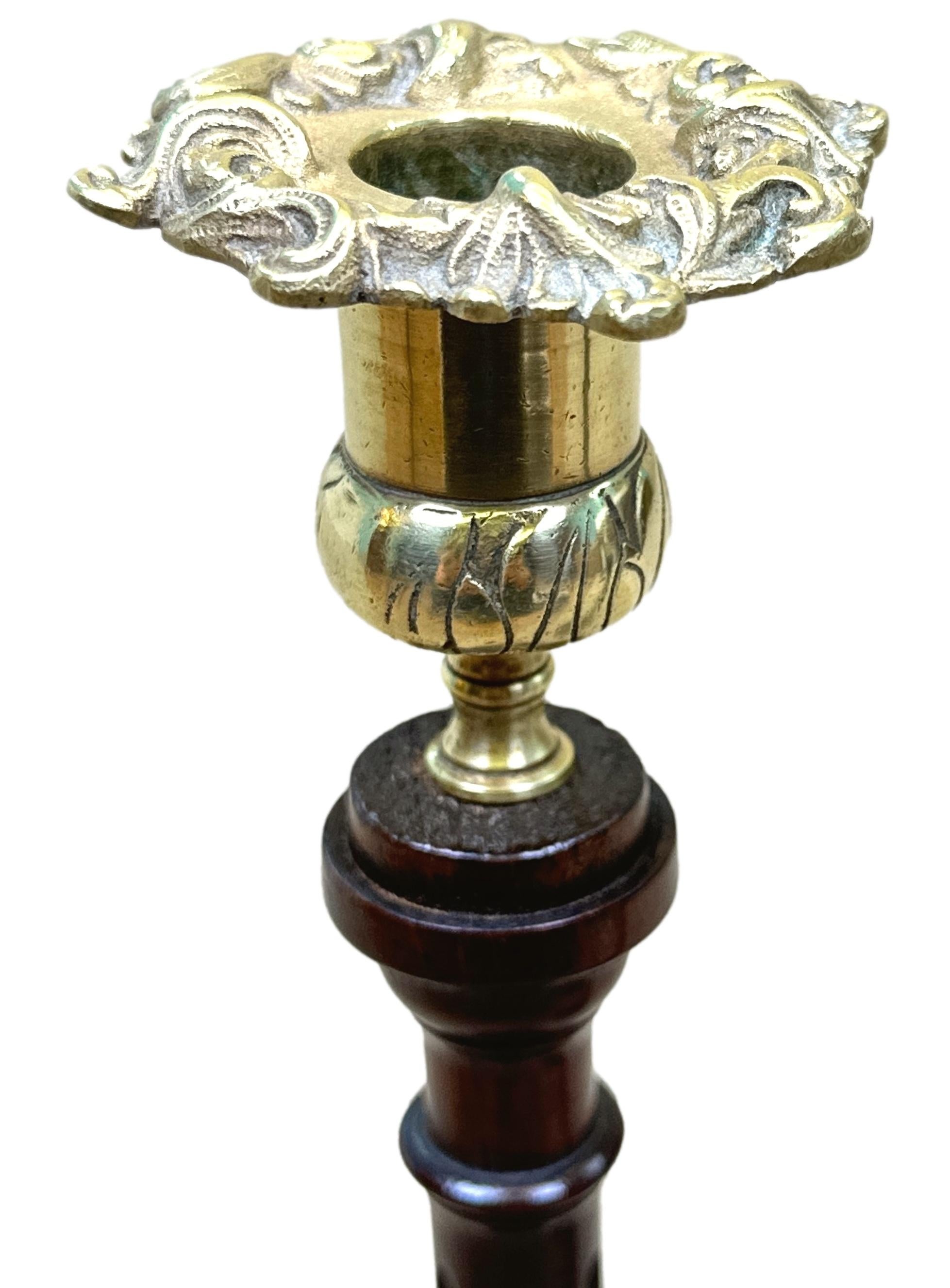 A Good Quality And Attractive Late 19th Century Pair Of Mahogany And Brass Candlesticks, In The 18th Century Georgian Style, Having Charming Foliate Cast Brass Nozzles Over Elegant Fluted, Turned Shafts, With Twisted Carving To Bottom Raised On