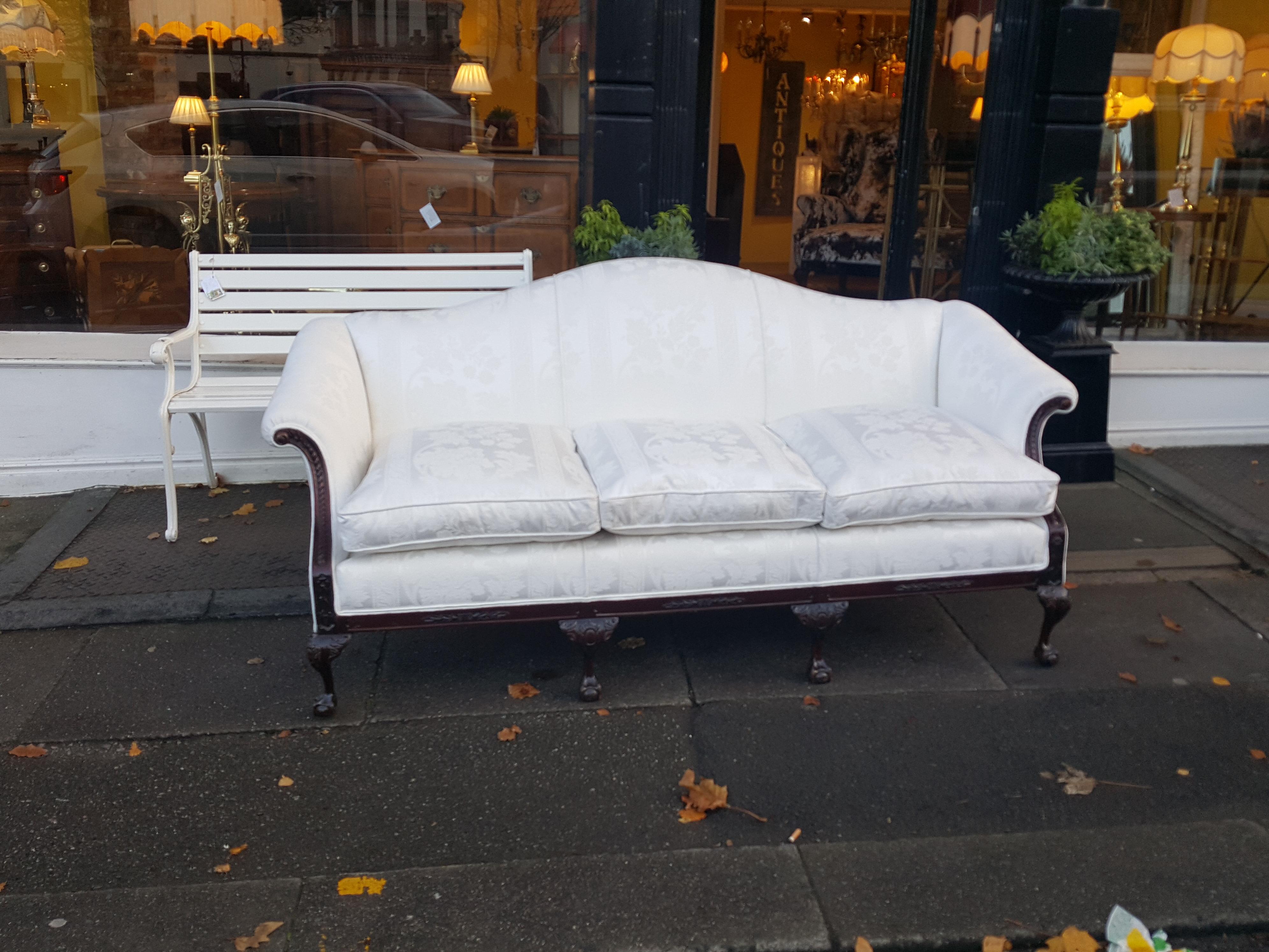 Late 19th century mahogany camel back sofa with 4 Chippendale style ball and claw feet.
Measures: 81