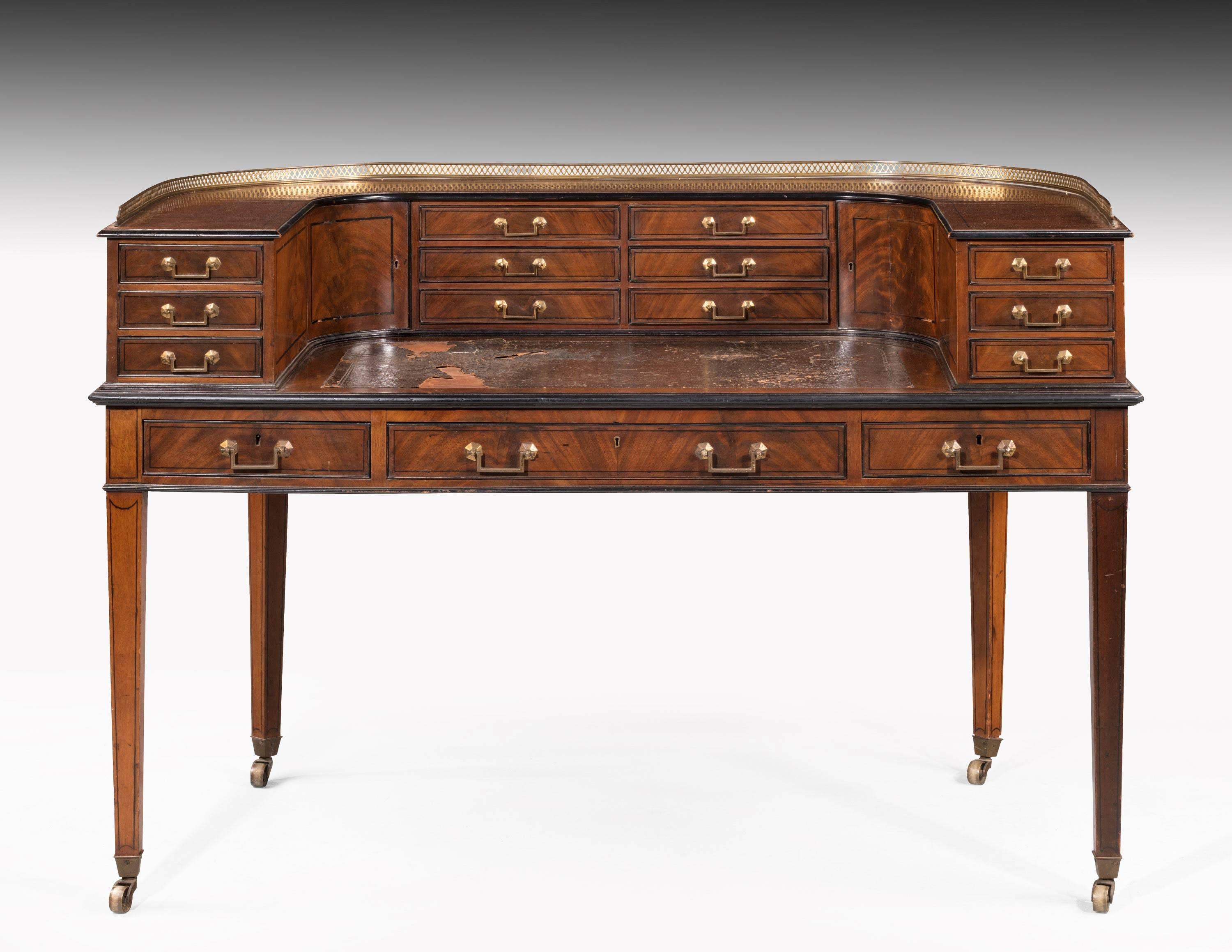 A very finely made mahogany Carlton House desk on tapering square supports. Retaining the original shoes, castors and square brass handles. The handles still retaining a good amount of gilding. Quite outstanding cabinetmaking and in exceptional