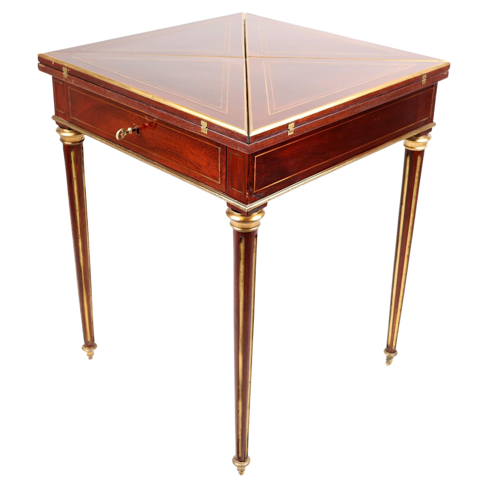 Late XIX Century envelope game table,
France, 1890-1900
Mahogany 

An elegant French envelope game table with brass inlaid. 
By opening the four hinged triangular sections, reveals to us a green felt game surface. Under the game plate, a single