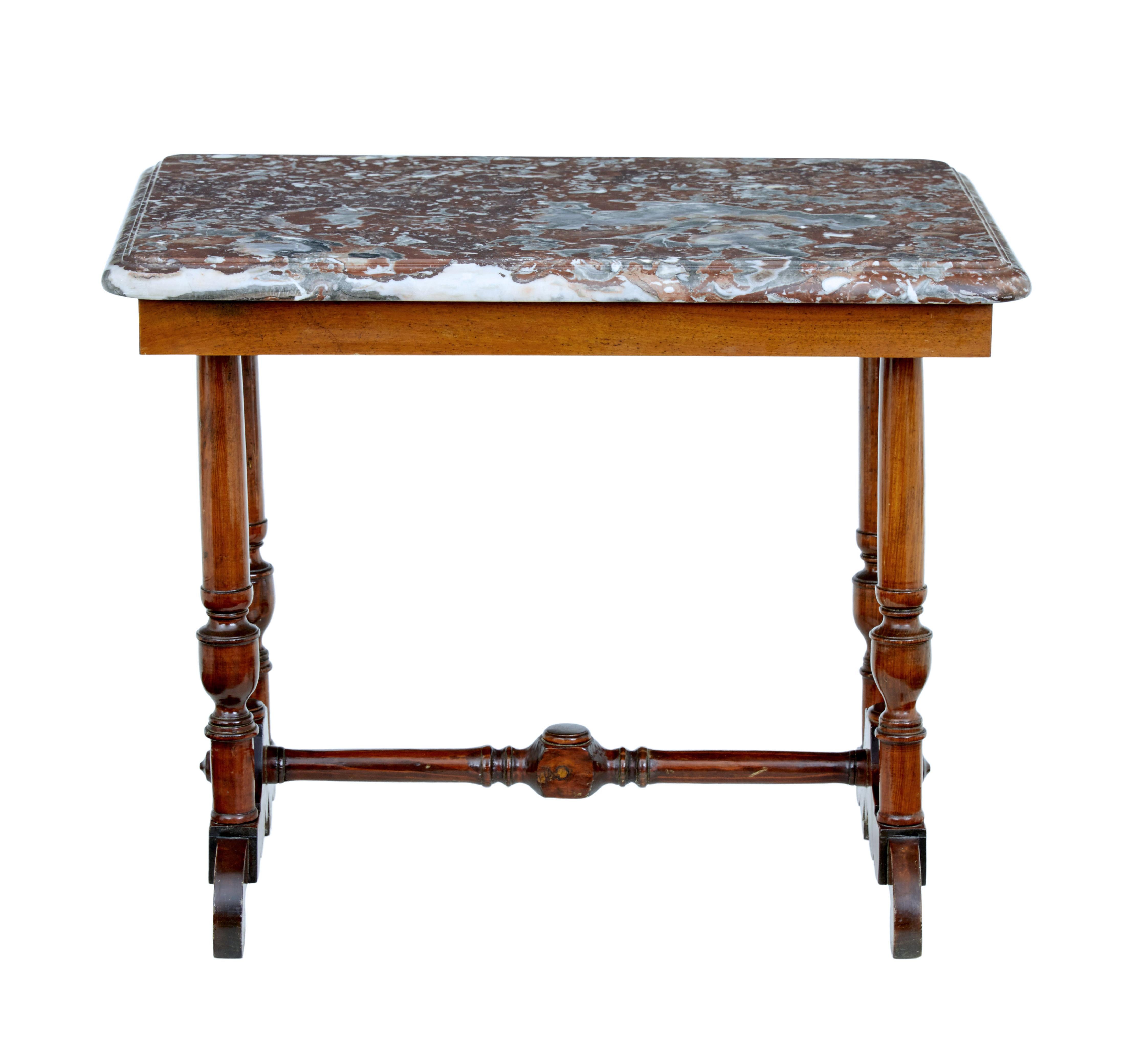 Unusual mahogany and marble side table, circa 1890.

Mahogany frame table with a substantial marble top. Base with 4 turned legs and scrolling feet united by stretcher. Original marble top with bull nosed edge.

Multiple uses such as a lamp or