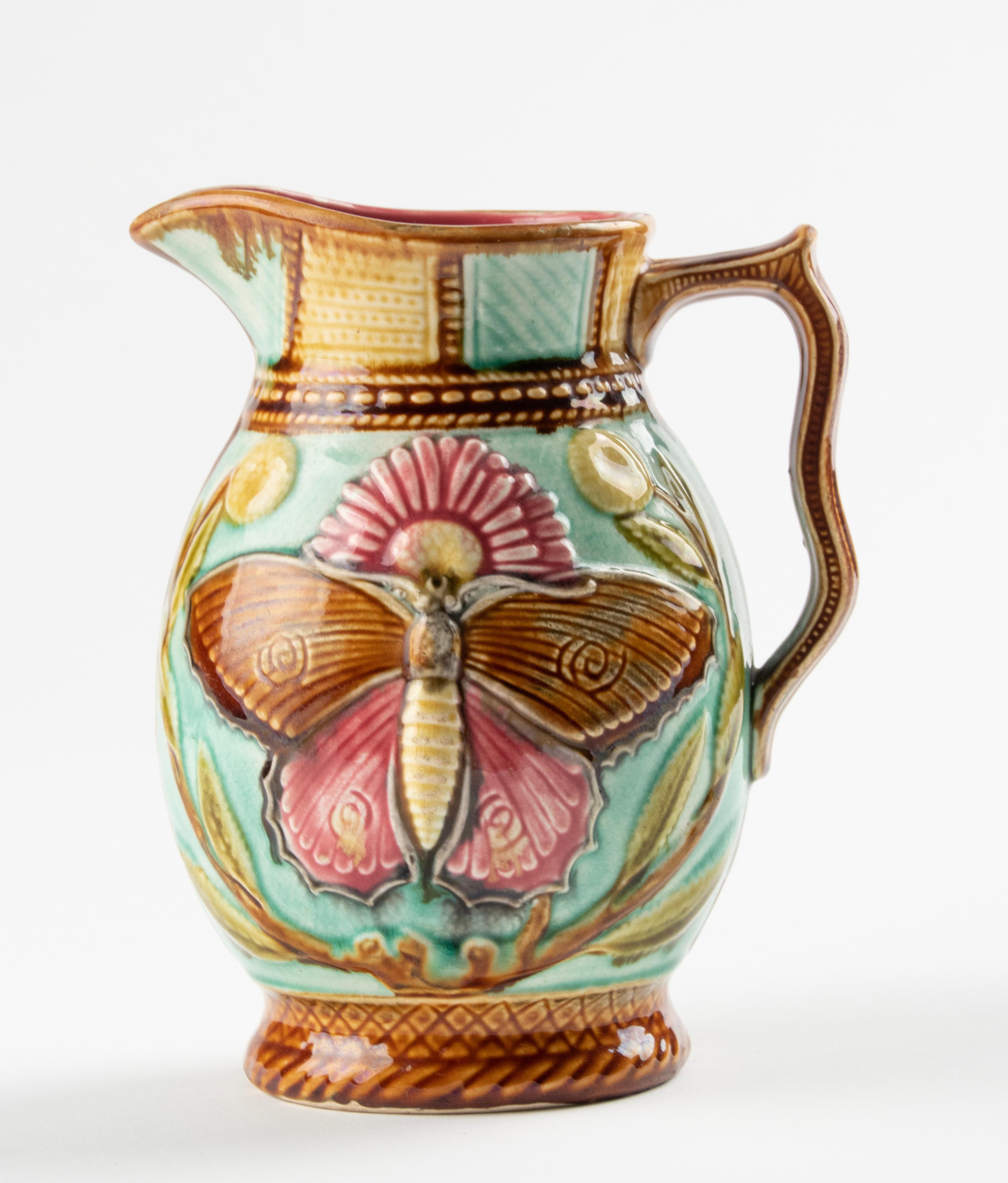 Lovely majolica ceramic pitcher. Beautiful decor with a large butterfly and vibrant colours. The jug is marked on the bottom, but the mark is not legible. Presumably French.
The jug is in good condition.