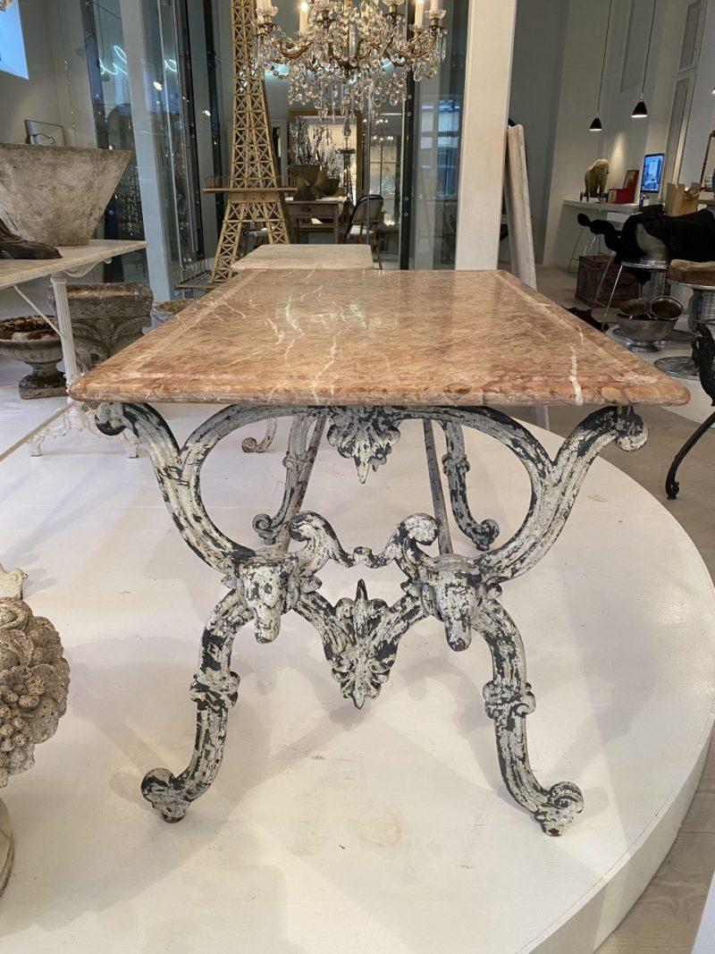 Beautiful antique French butcher’s table with large marble top and the most fantastic curved base in quality iron, with many beautiful details, such as bull heads etc.

The table appears with the most delightful rustic and original patina. Butcher’s