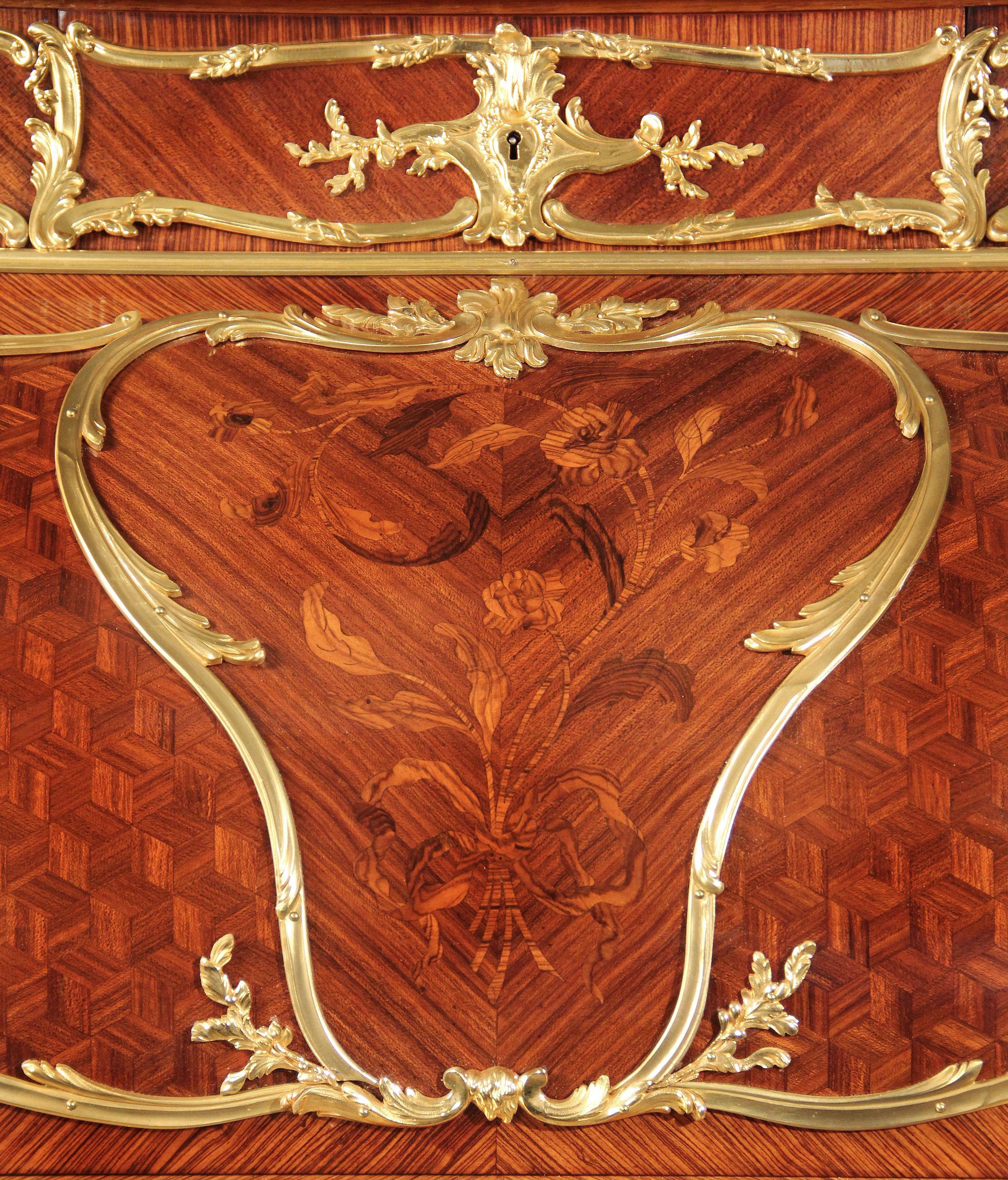 A special late 19th century Louis XV style gilt bronze mounted marquetry and parquetry bureau a cylindre.

By François Linke - Index no. 393.

The upper section with a shaped pierced acanthus gallery, above three frieze drawers centered by a