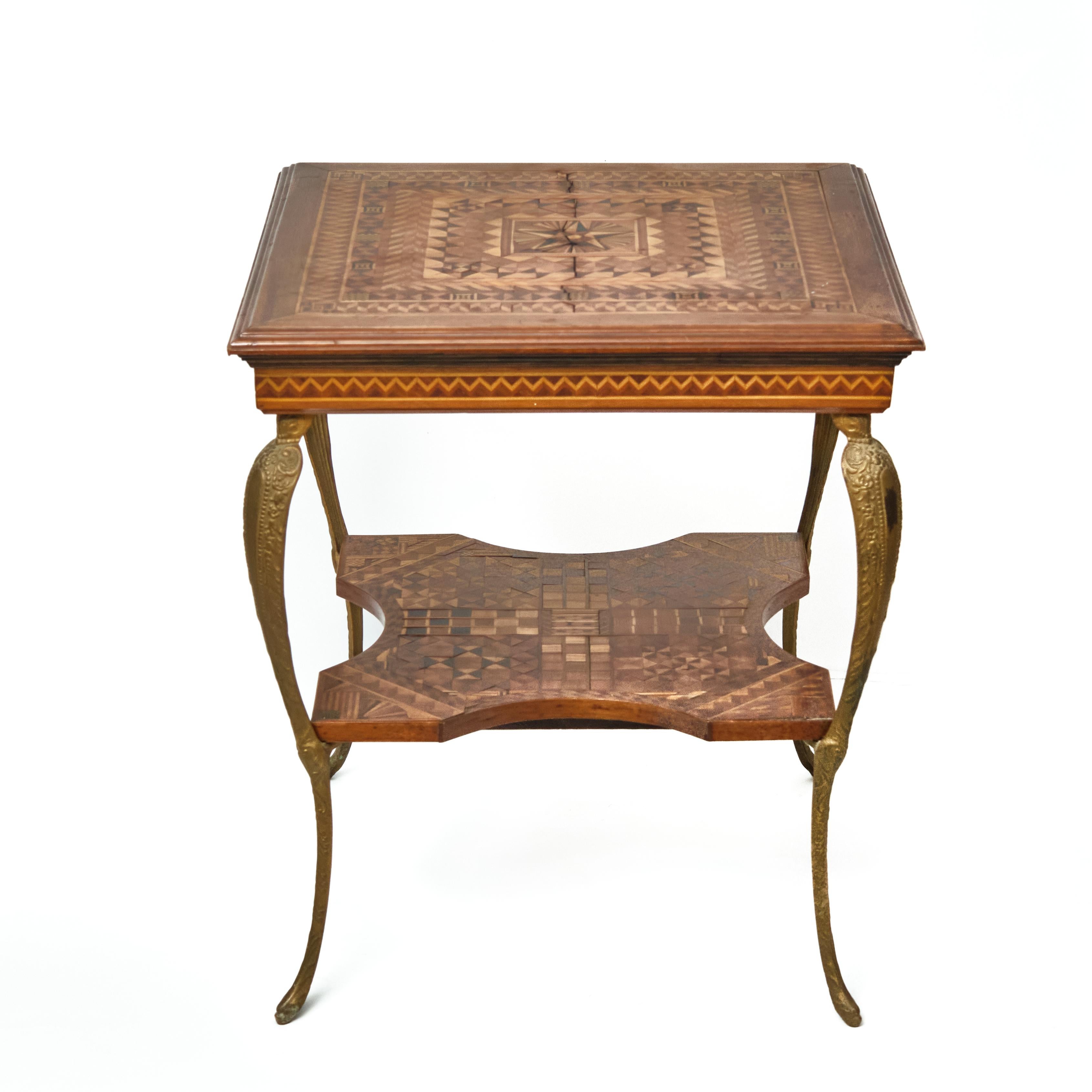 Late 19th century marquetry inlaid parlor, or side table. The square top with molded edges raised on cast brass cabriole legs having a square medial shelf with concave cutouts. Extensive marquetry inlay of geometric designs on both top and