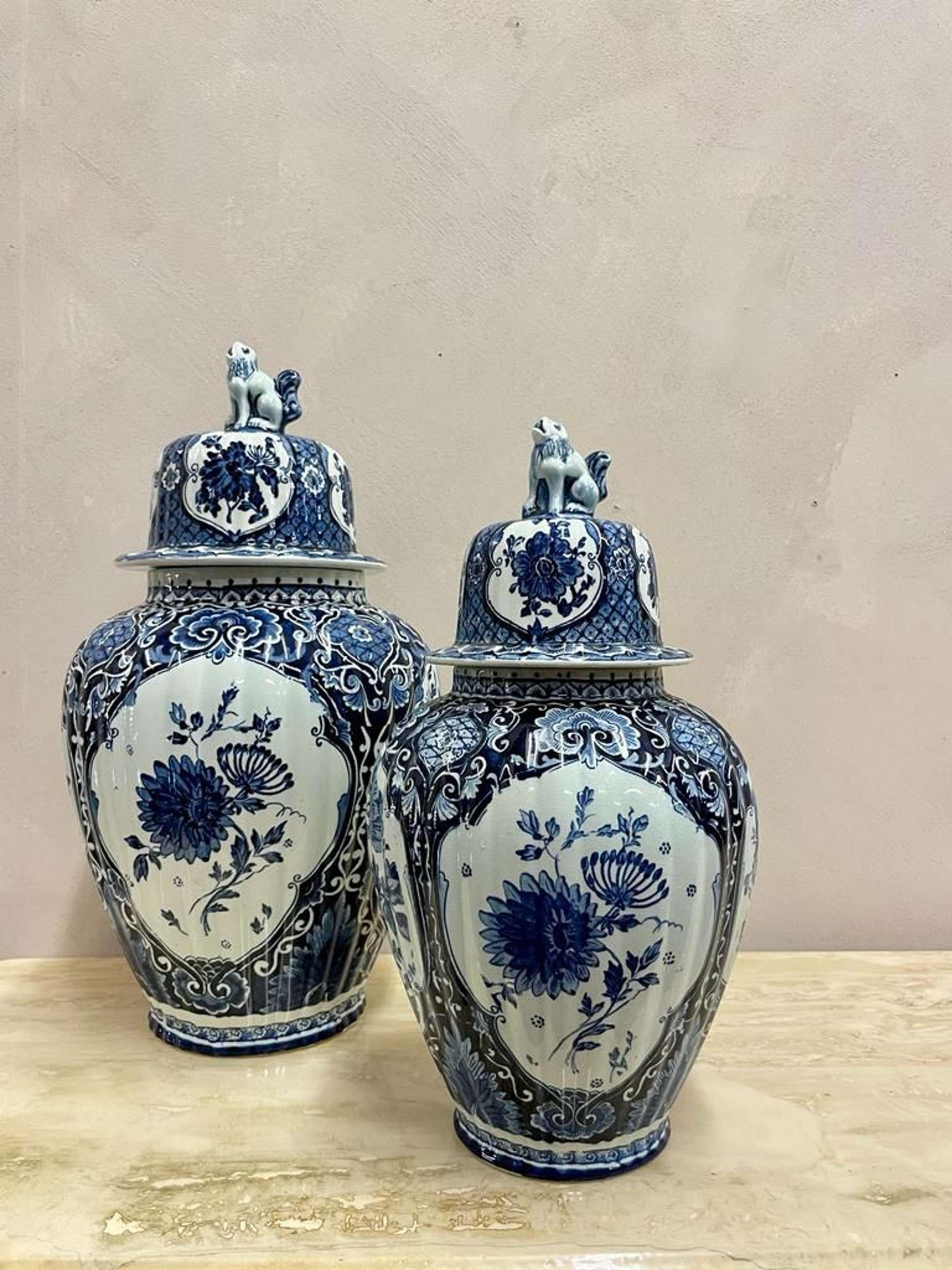 A 'his and hers' sized pair of late 19th century Dutch Delft Ginger Jars, by Petrus Regout, Maastricht.
Domed covers are mounted by typical Foo Dogs.
These jars date to after 1879, when the firm starte using the image of a sphynx as a logo and