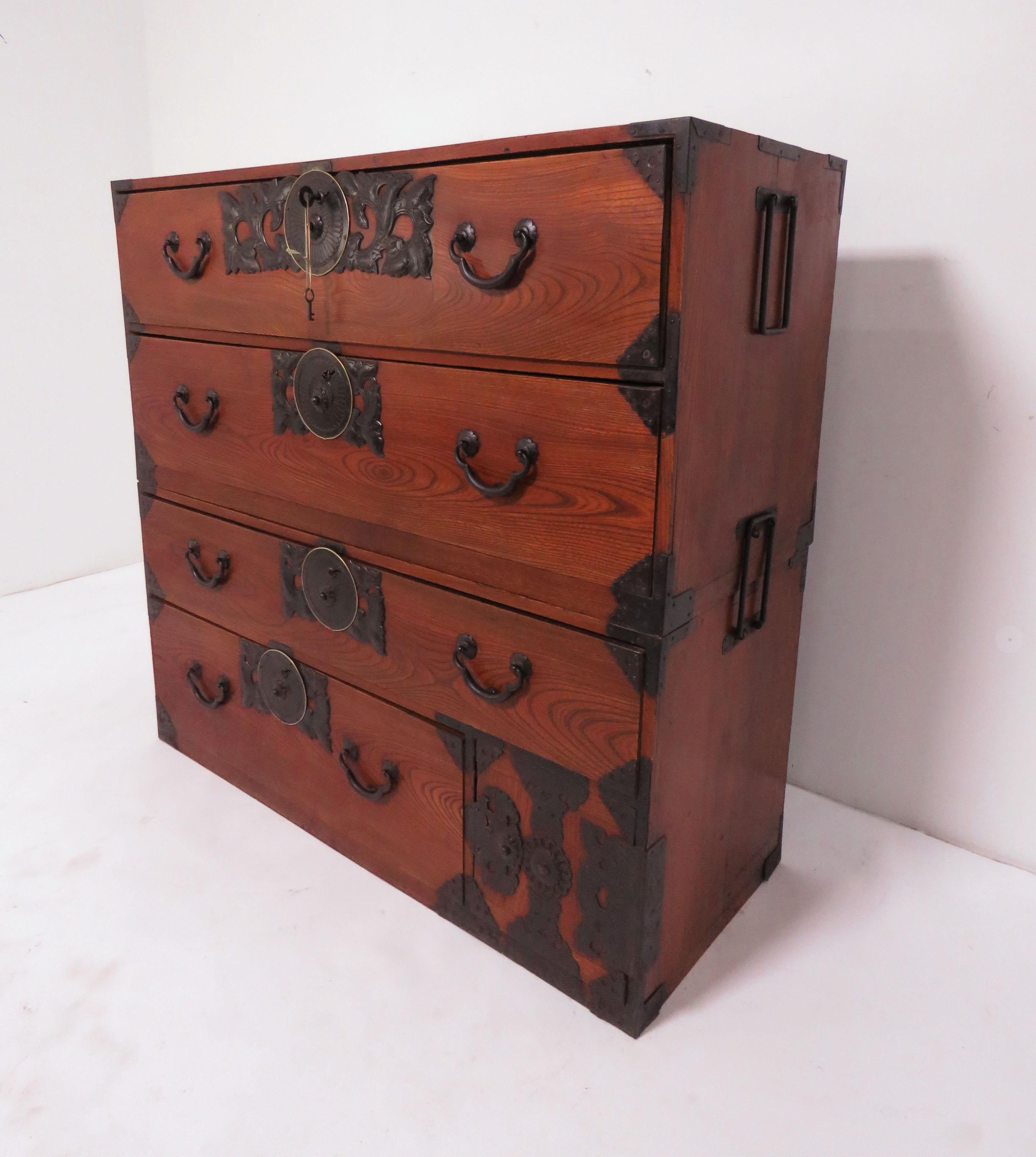 A late 19th century, Meiji period Kasane Tansu chest on chest from the Yonezawa region of Japan. Lacquered kiriwood and elm drawer fronts with hand forged iron hardware. Originally used for silk and kimono storage, makes an excellent dresser as