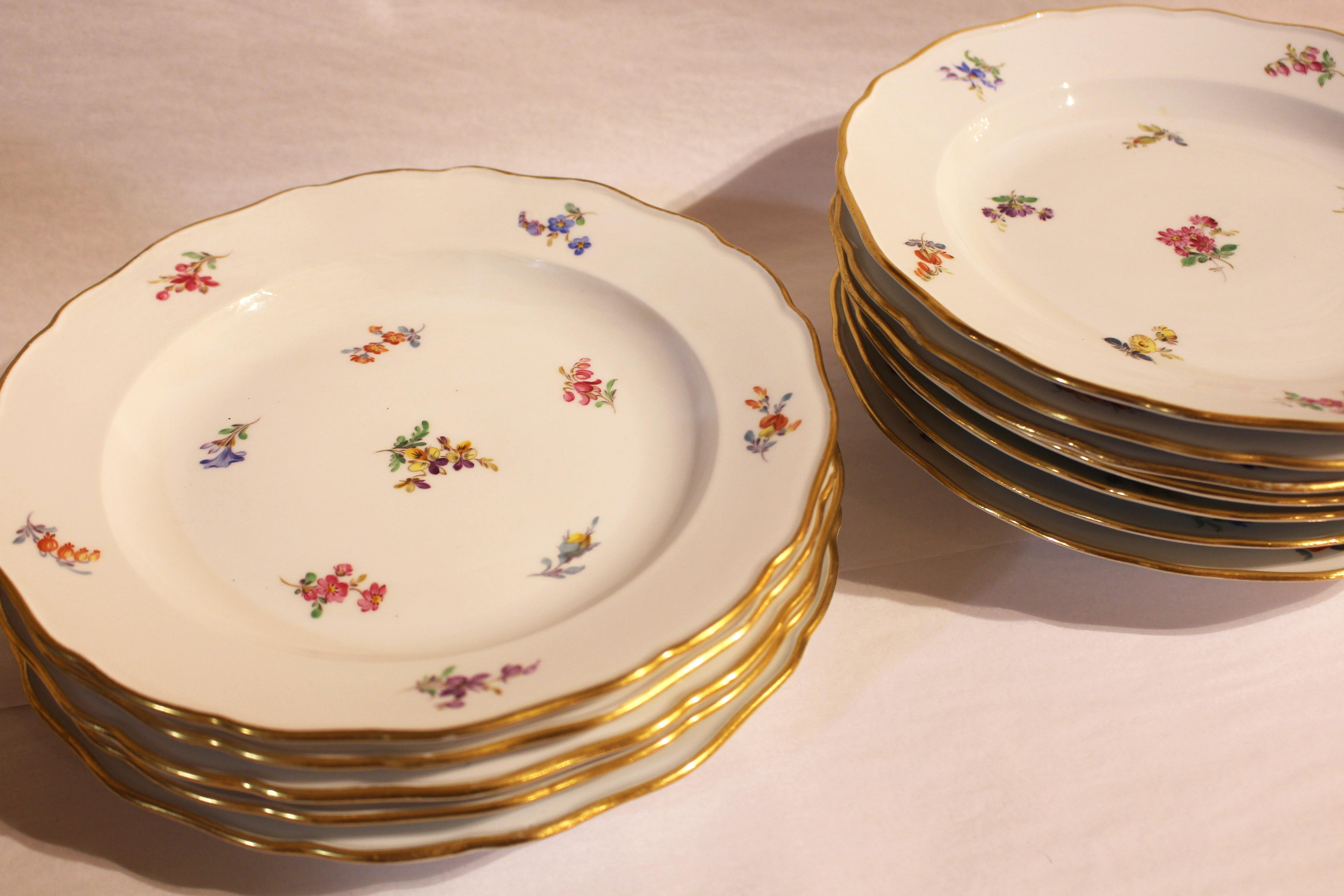 Set of 12 dinner plates, gilt scalloped edge (minor wear), Meissen's scattered flowers or streublumen pattern. Crossed swords mark on each. C.1860-90. 9 3/4
