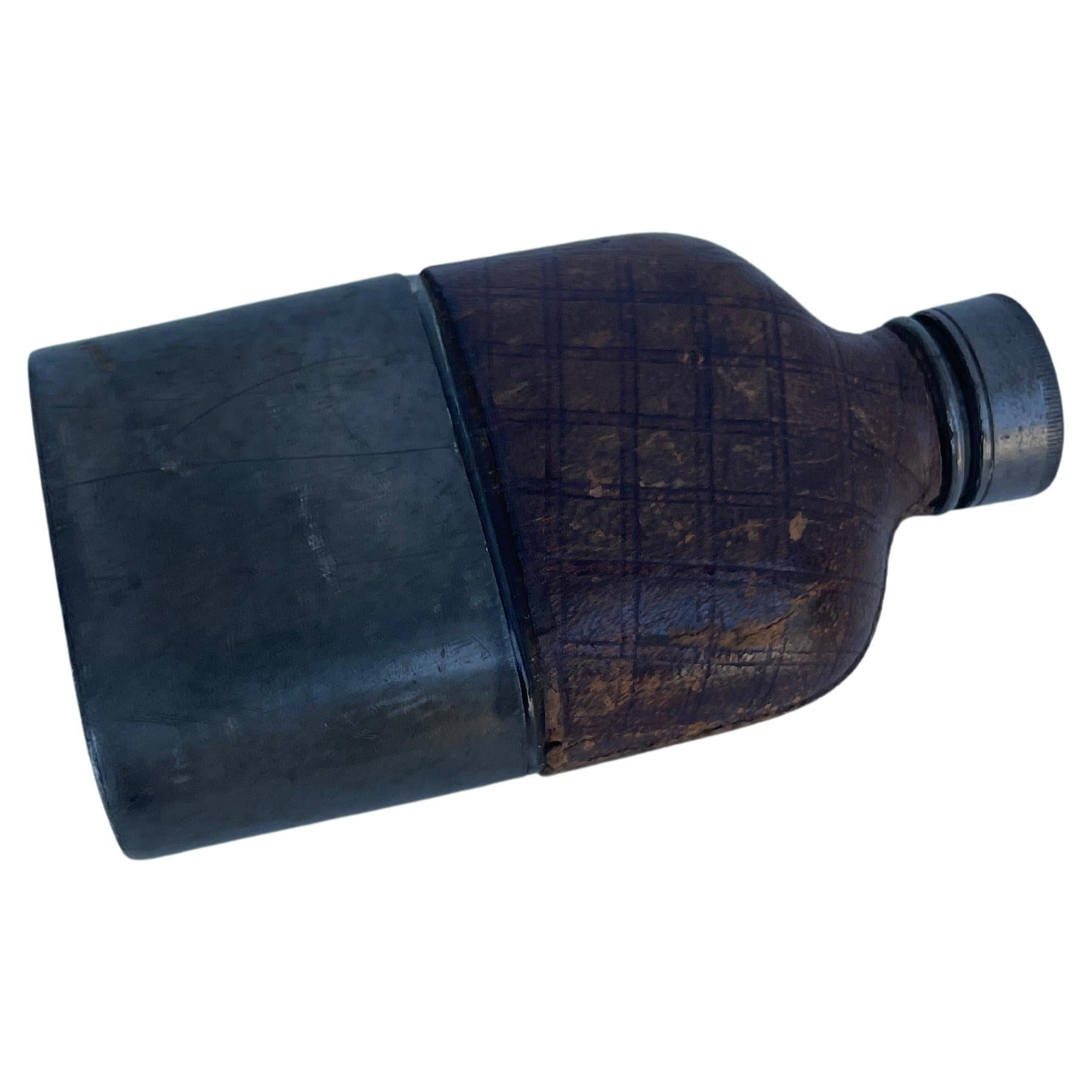 Military Pewter Leather Pocket Hip Flask, Civil War Era, circa 1890

Heavy glass flask wrapped in the original weathered brown leather at the top. The bottom of the flask slides into an oval pewter base which also functions as a cup. The mouth of