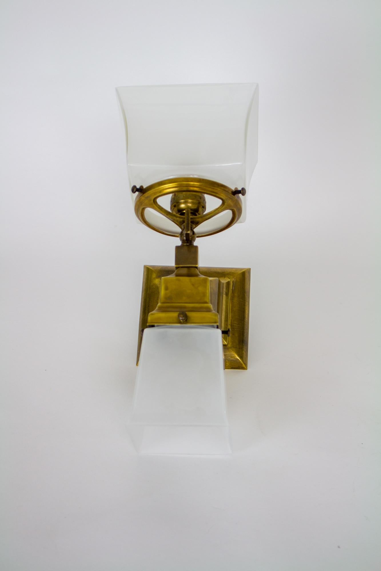 Classic squared Mission style sconces. Originally has gas jets facing upwards with 4” fitter shades, and electric lights facing downwards with 2 ¼” fitter shades. Backplates are 4.5” square. Gas elements have been converted to electric, maintaining