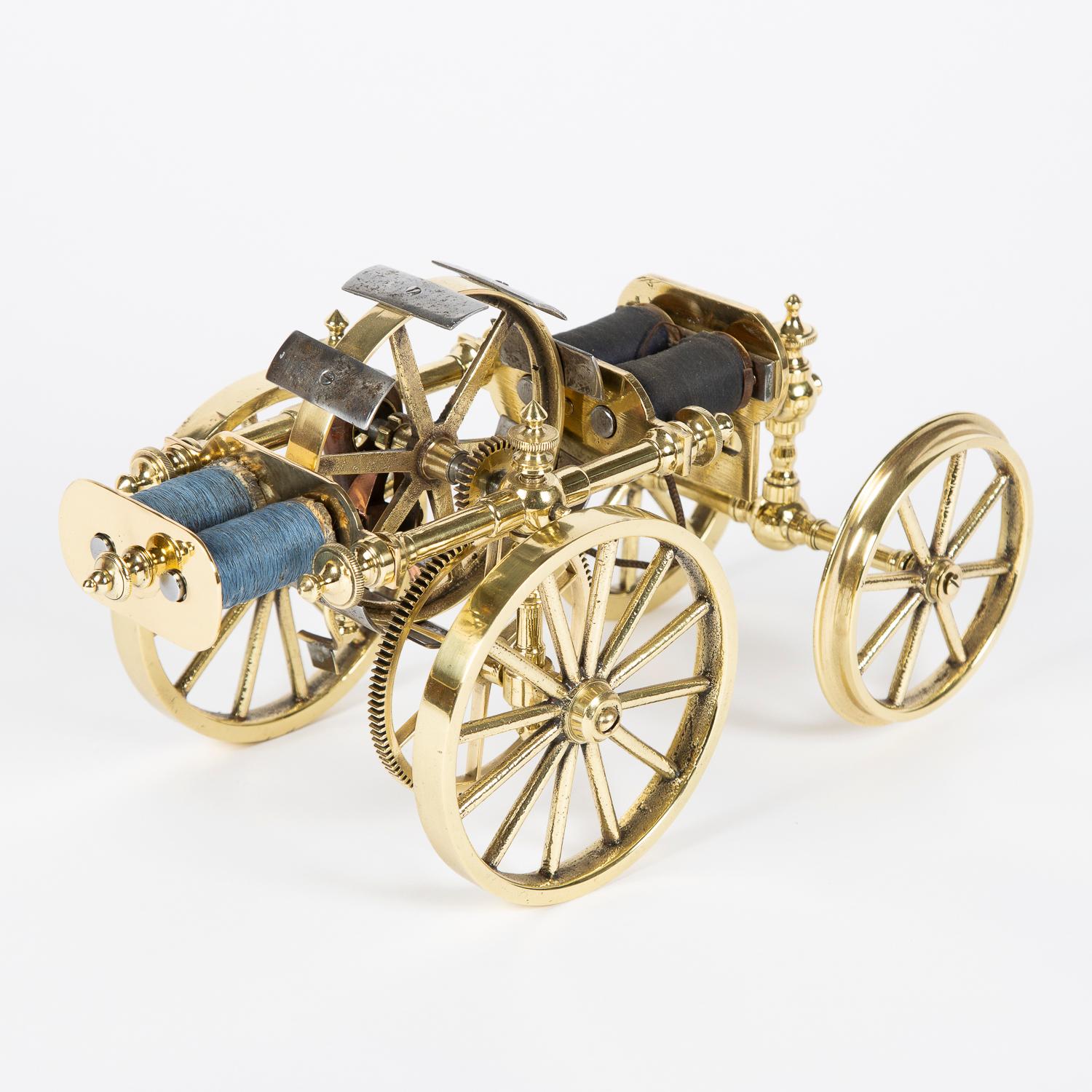 A late 19th century brass model of an electric powered road locomotive.

4 inch rear wheels with gear drive from electric motor, front 4 inch wheels with rail flange and steering.