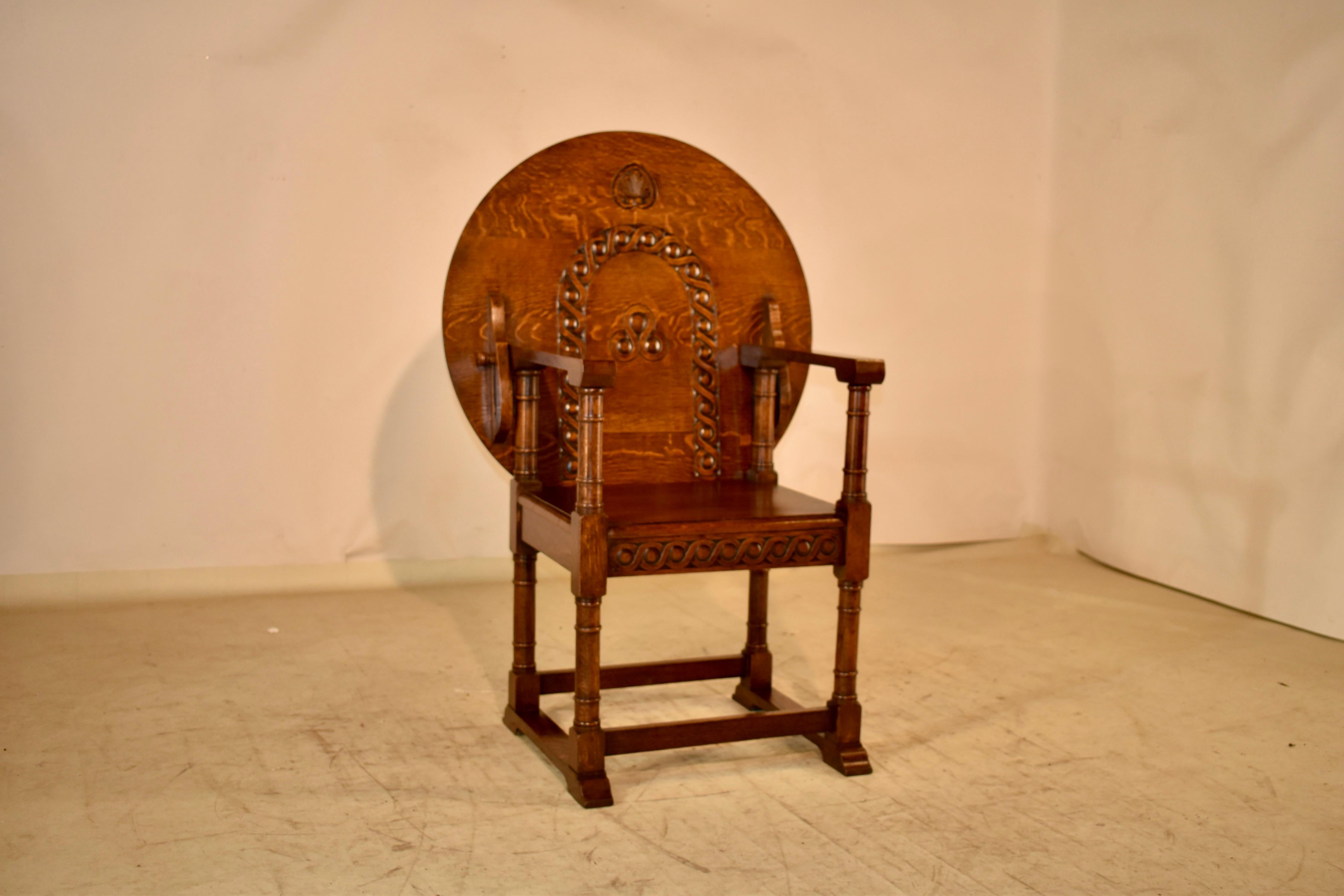 Late 19th century oak Monk's seat from England. When the top is up, it can be used for comfortable seating. The seat back has hand carved details for added interest. The seat can then be converted easily into a table top by sliding the back of the