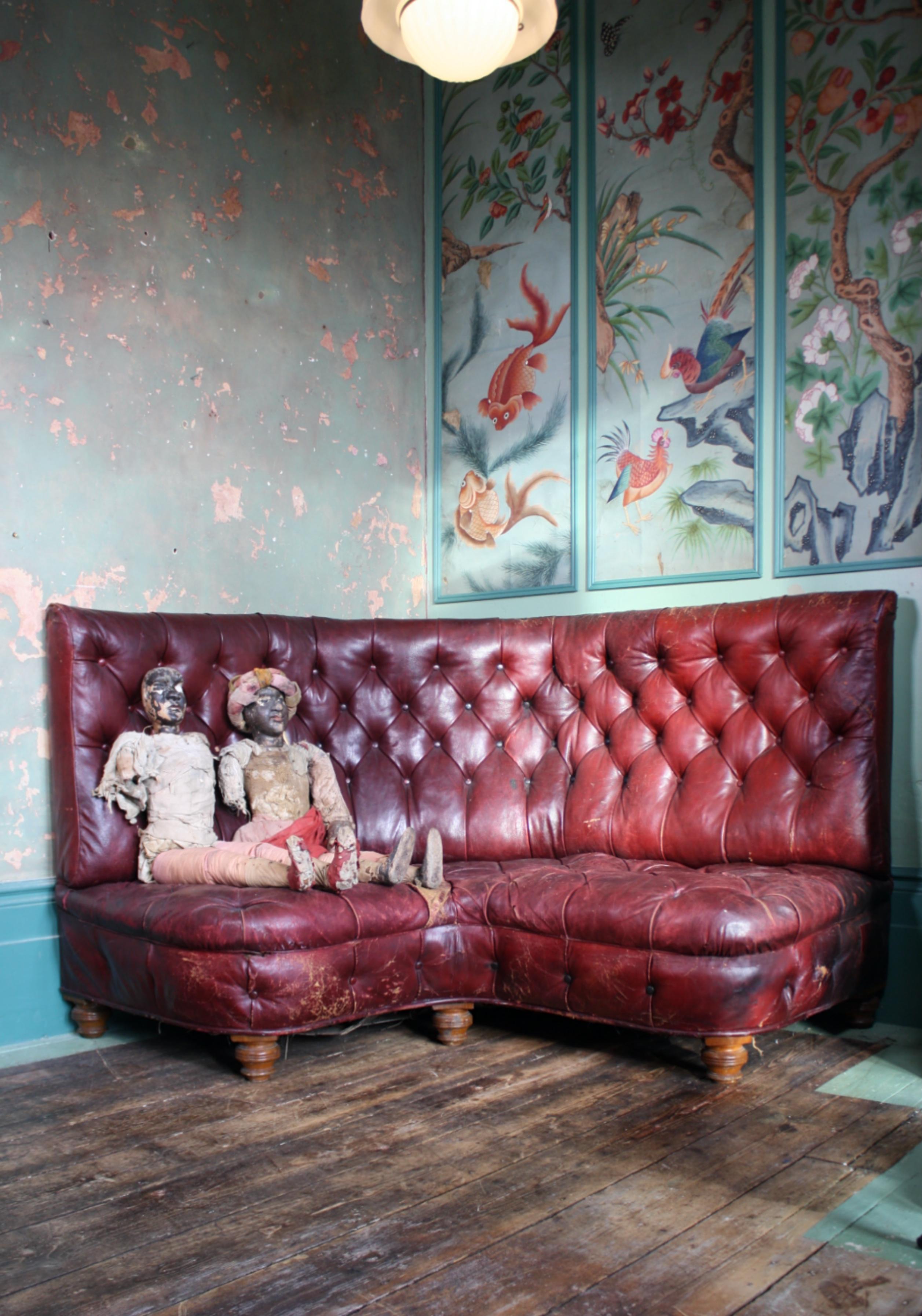 A very original late 19th century corner sofa, likely a bespoke piece for a hotel, gentleman's club or the like.

The piece is offered in untouched condition, some minor patching and elderly repairs. The sofa sits on six turned hardwood legs, it