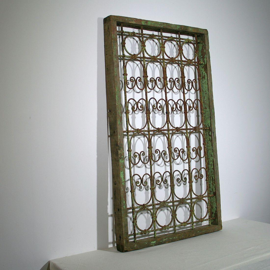 Great Moroccan window frame with wrought iron bars. Beautiful traces of old green color. Morocco, circa 1880-1900
Weathered.