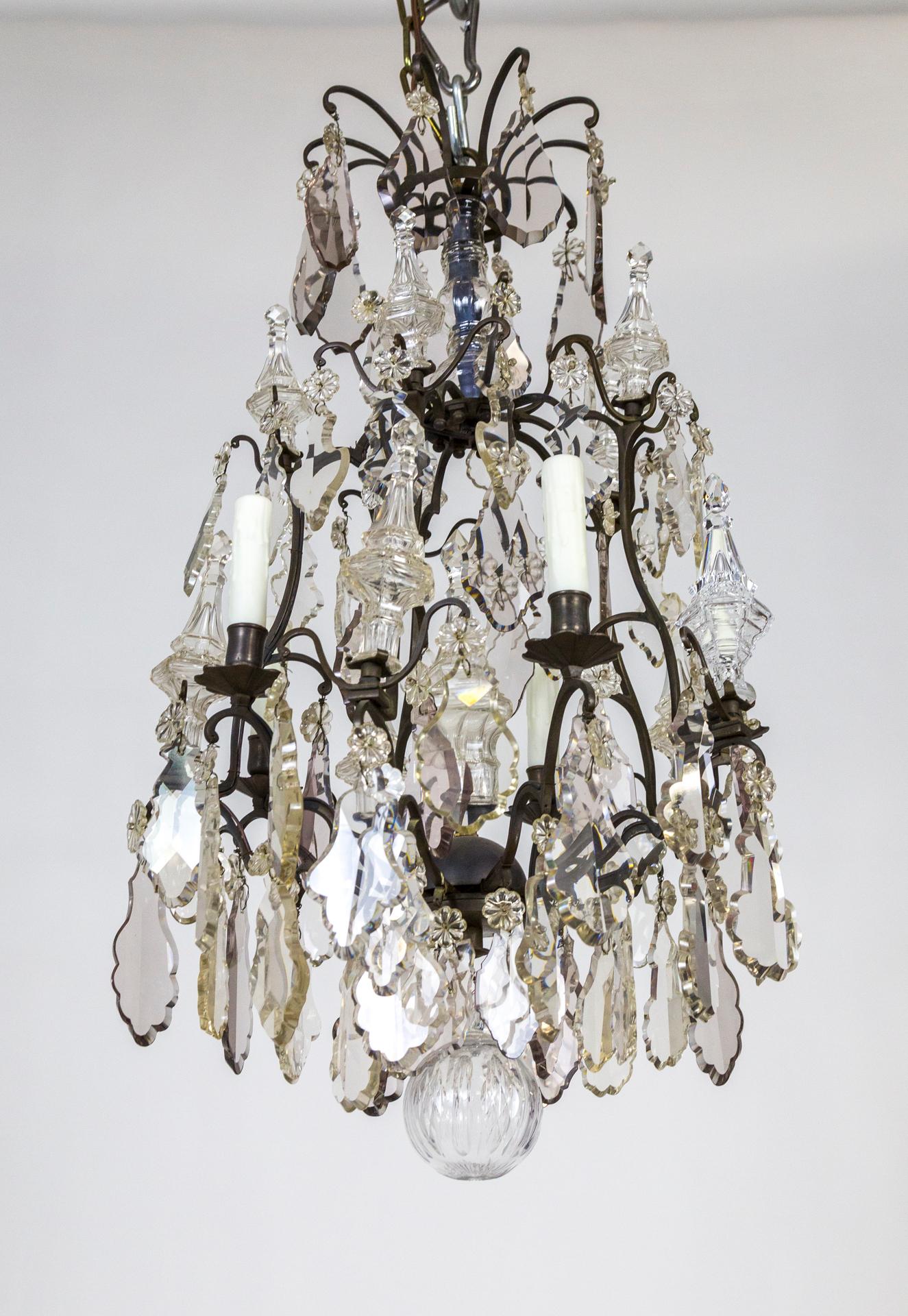 A Belle Epoque period blackened bronze, birdcage chandelier with maximum, heavy crystals in clear and subtle, smoky amethyst; including large pendeloques and spires. A large, cut glass final ball. 5 lights. Newly rewired. 34.5