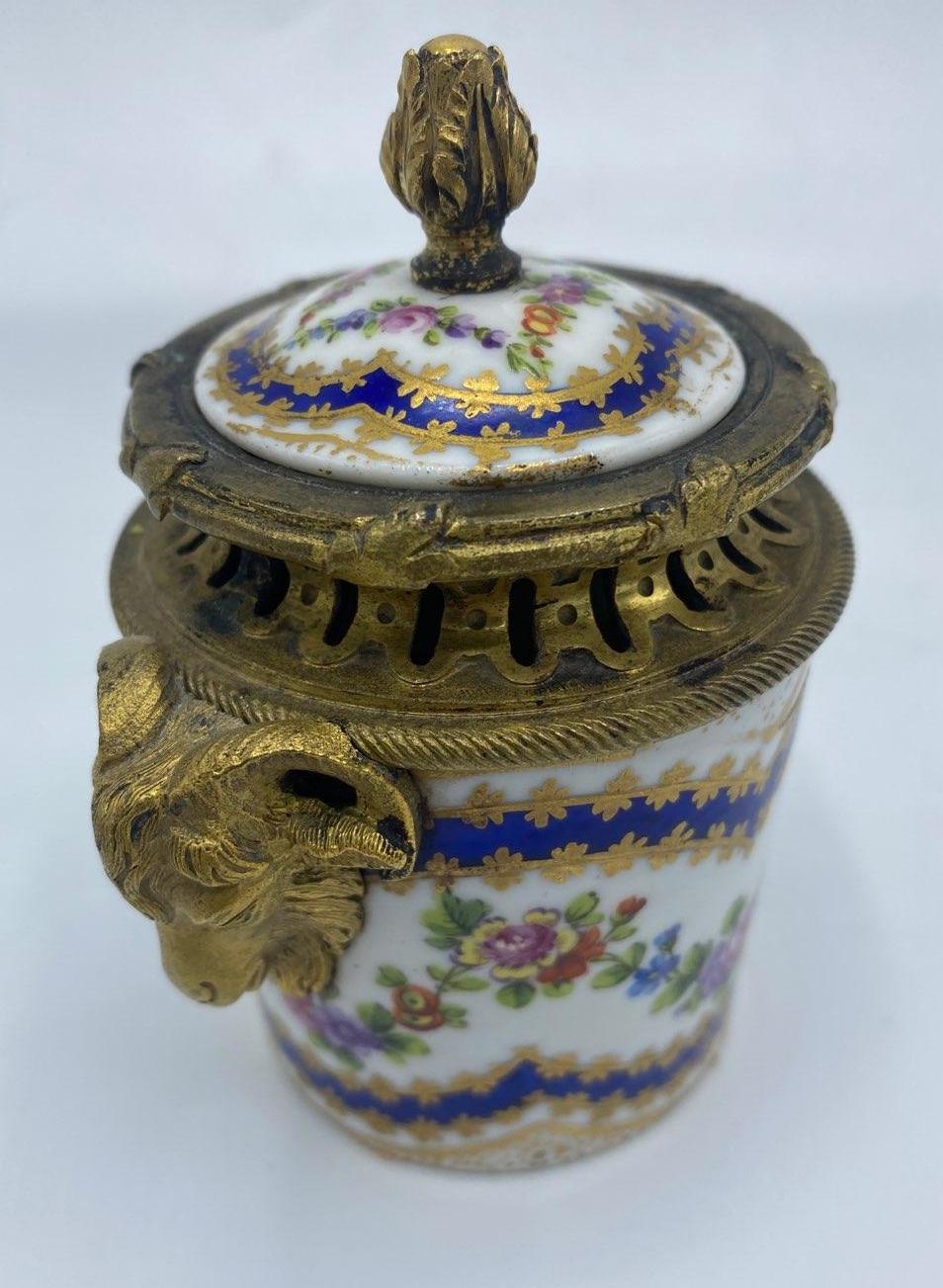 Late 19th Century Sevres French Floral Painted Porcelain Inkwell 
Lovely little porcelain piece painting with a floral design in pinks, purples and greens accented with blue and gold gilt paint. Marked on bottom. In excellent condition. France,