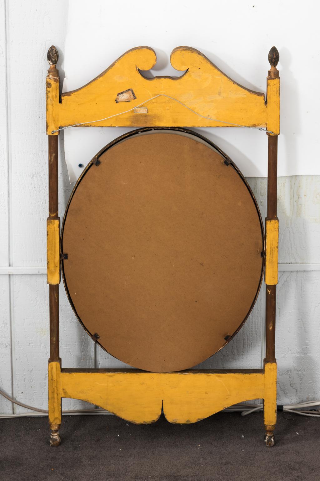 Antique hanging sign converted into a gilded neoclassical mirror with carved broken scroll crown and finials. From the United States. Please note that this mirror has original patina, the gilding has minor chips and wear with age, circa 1870s.