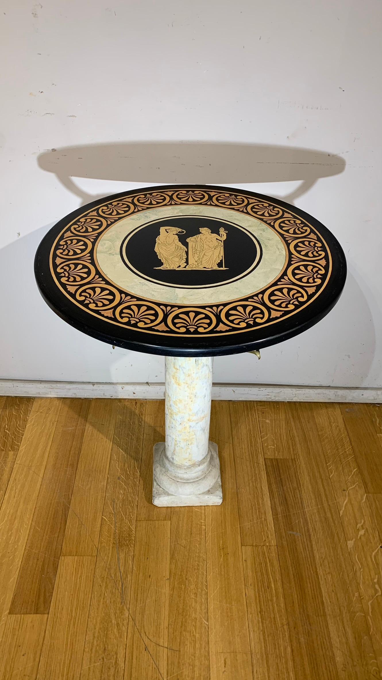 Beautiful side table made with the columnar shaft in white Carrara marble with partially gilded bronze details, scagliola top made with Pompeian-style decorations.

MEASUREMENTS: h cm 74, diameter cm 60